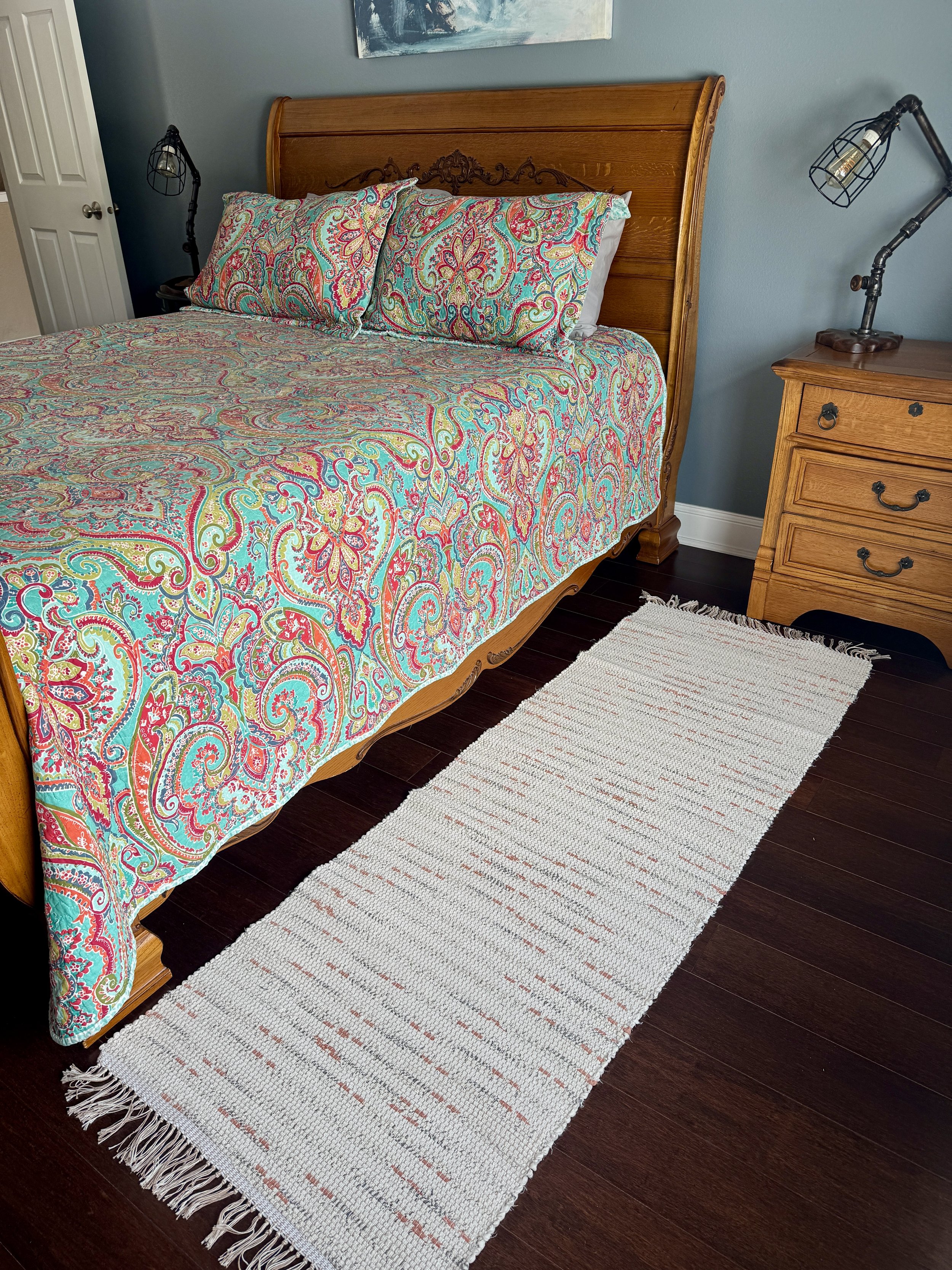 Displayed handcrafted rag rug in bedroom showing pattern