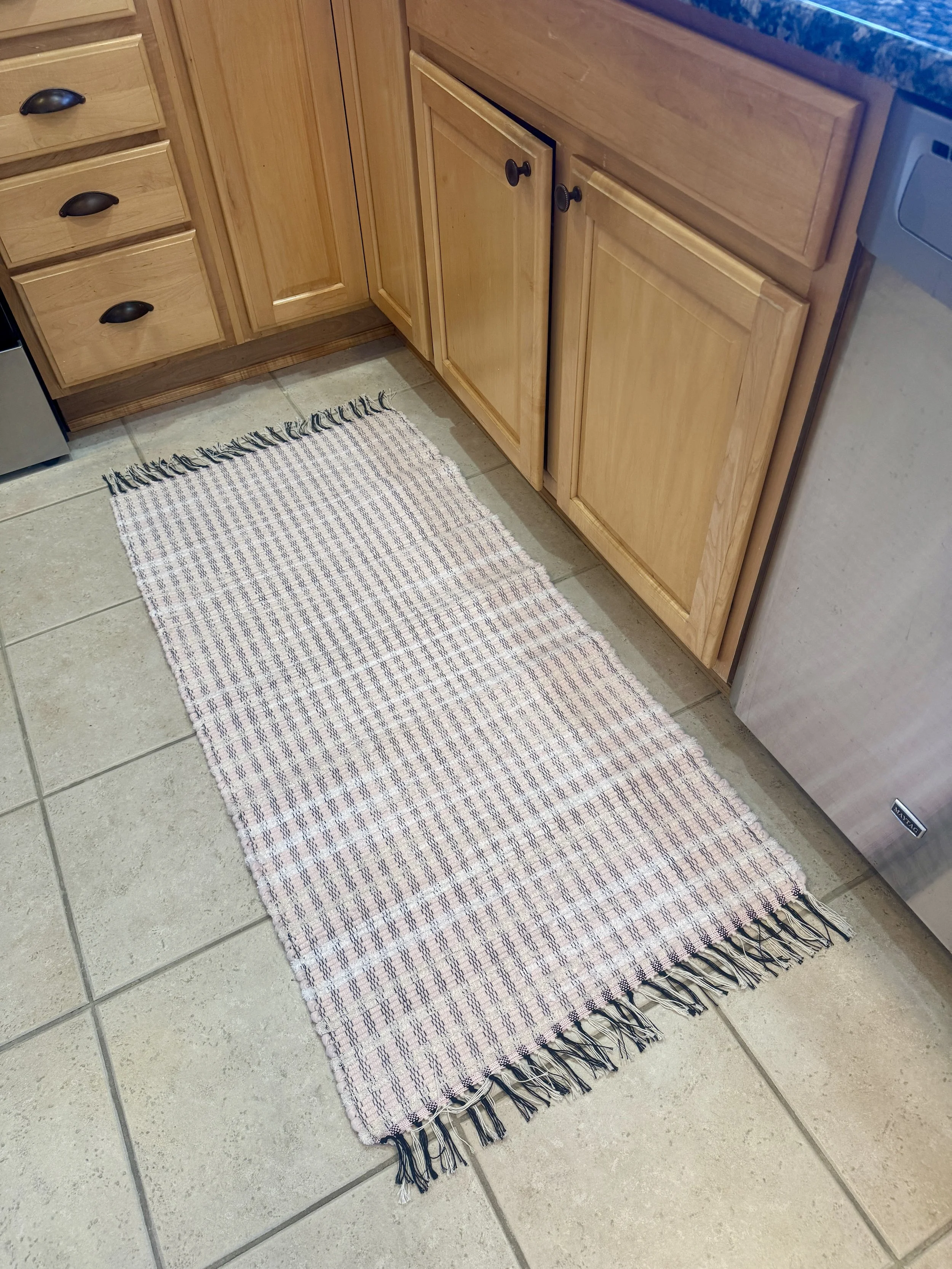 Displayed handmade rag rug in kitchen showing pattern and texture