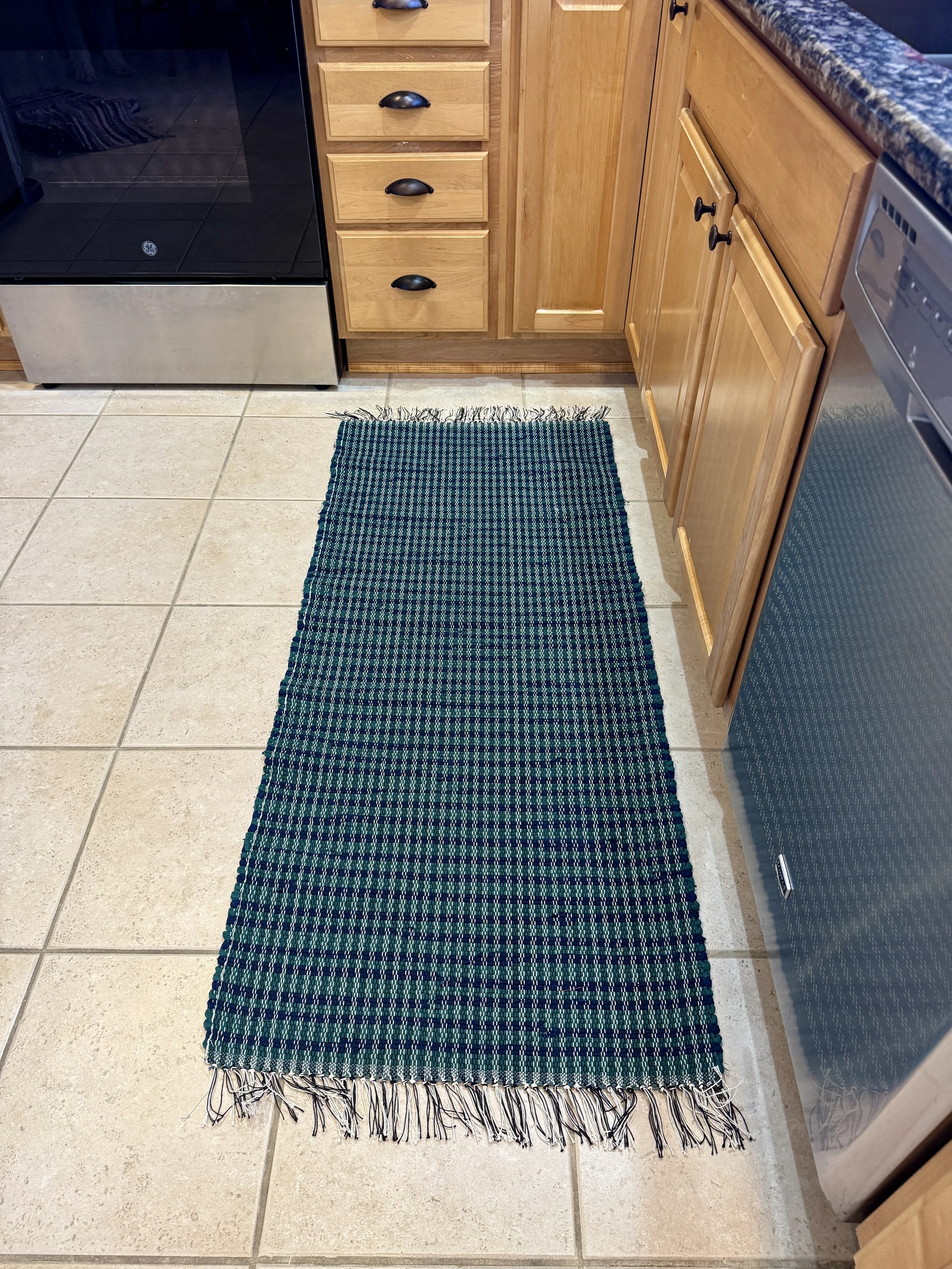Displayed handmade rag rug in kitchen showing pattern and texture