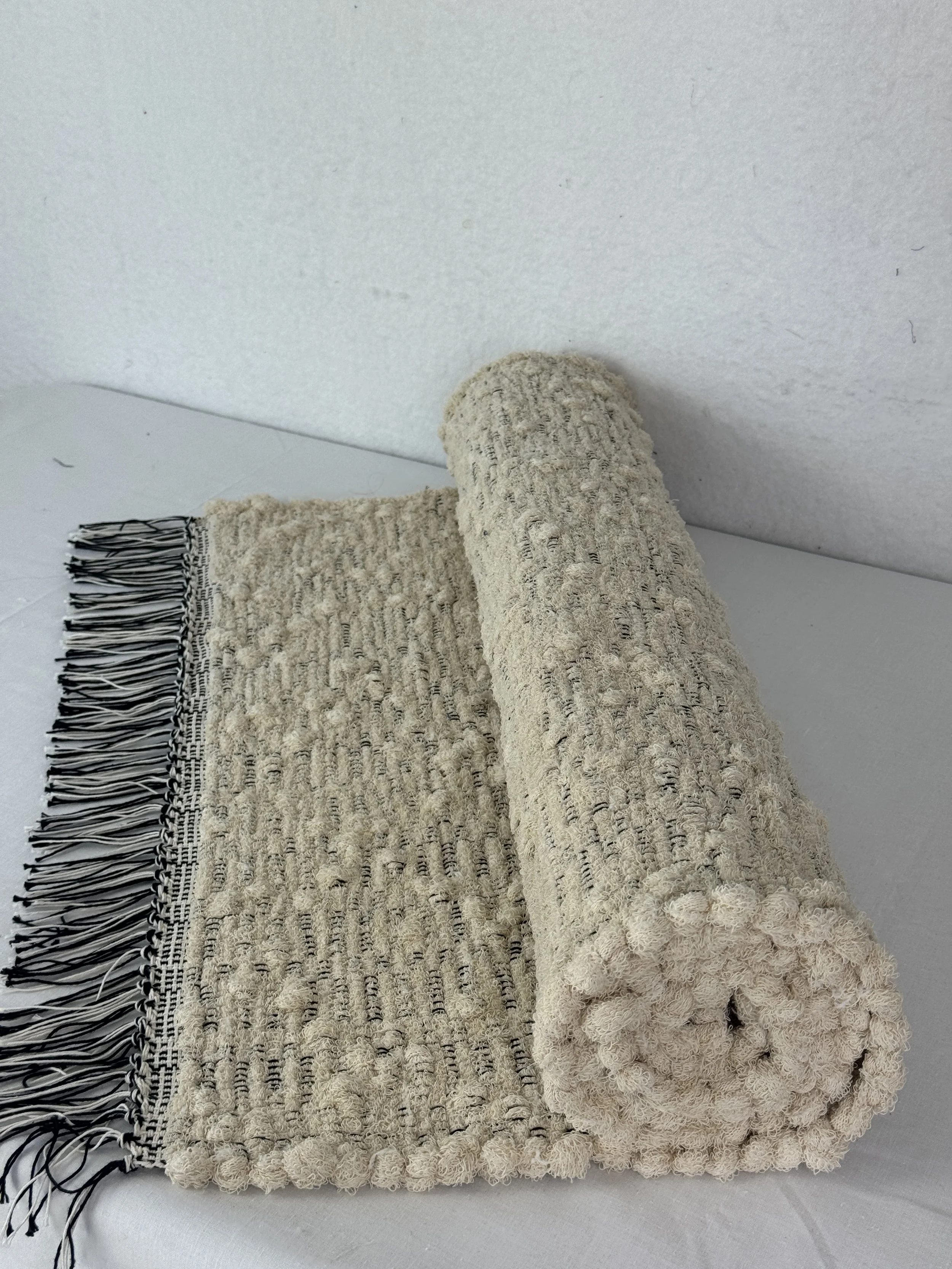 Handwoven cream rag rug made from upcycled sock loopers 25 x 53