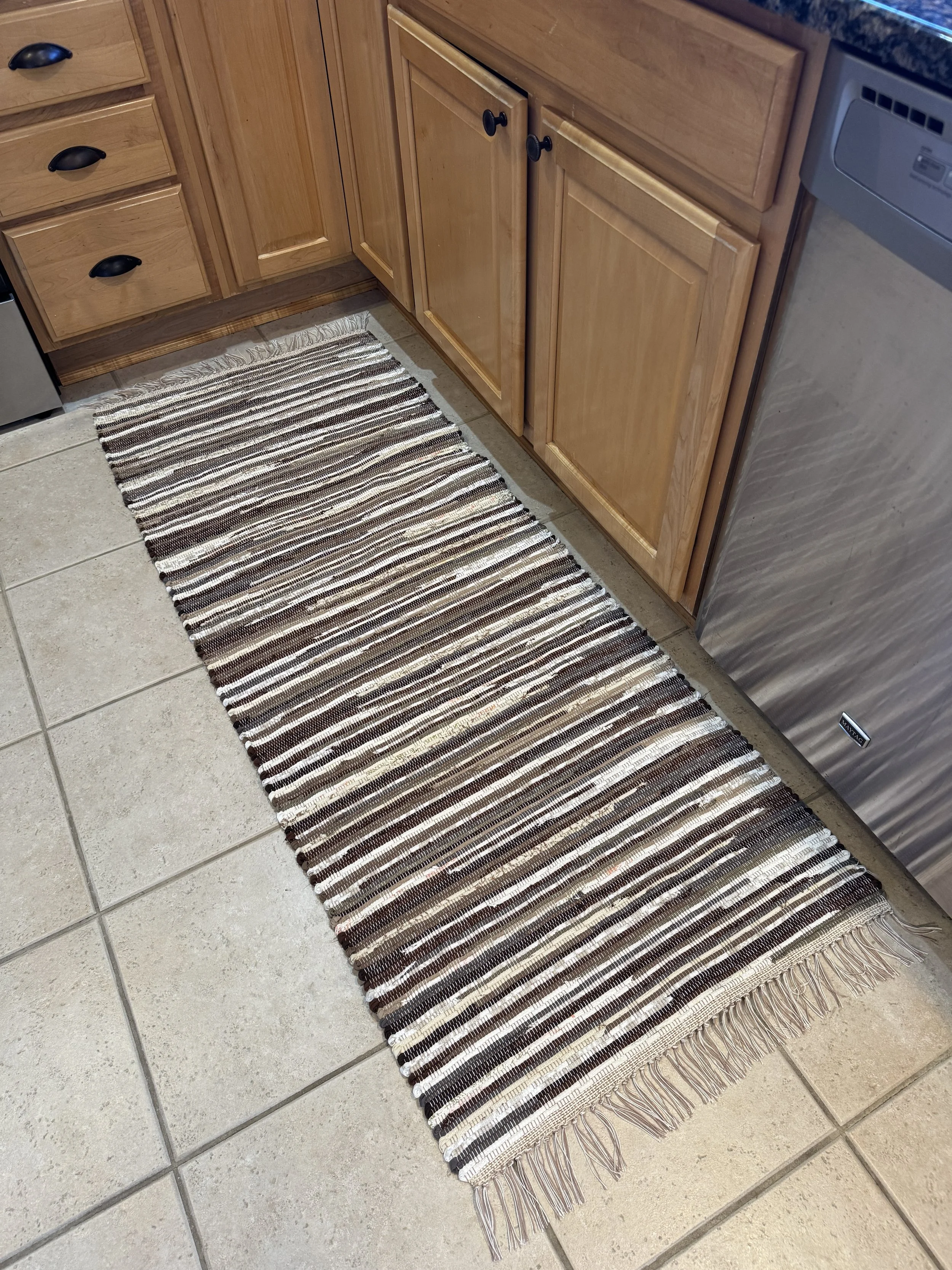 Handmade rag rug displayed in kitchen showing full pattern