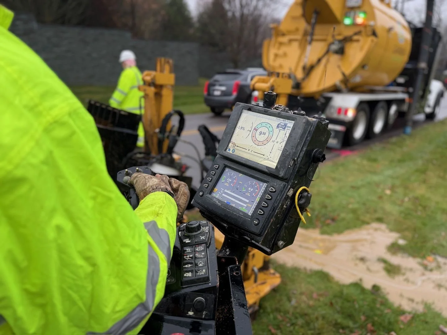 Directional drilling operator using a control panel for precise underground boring.