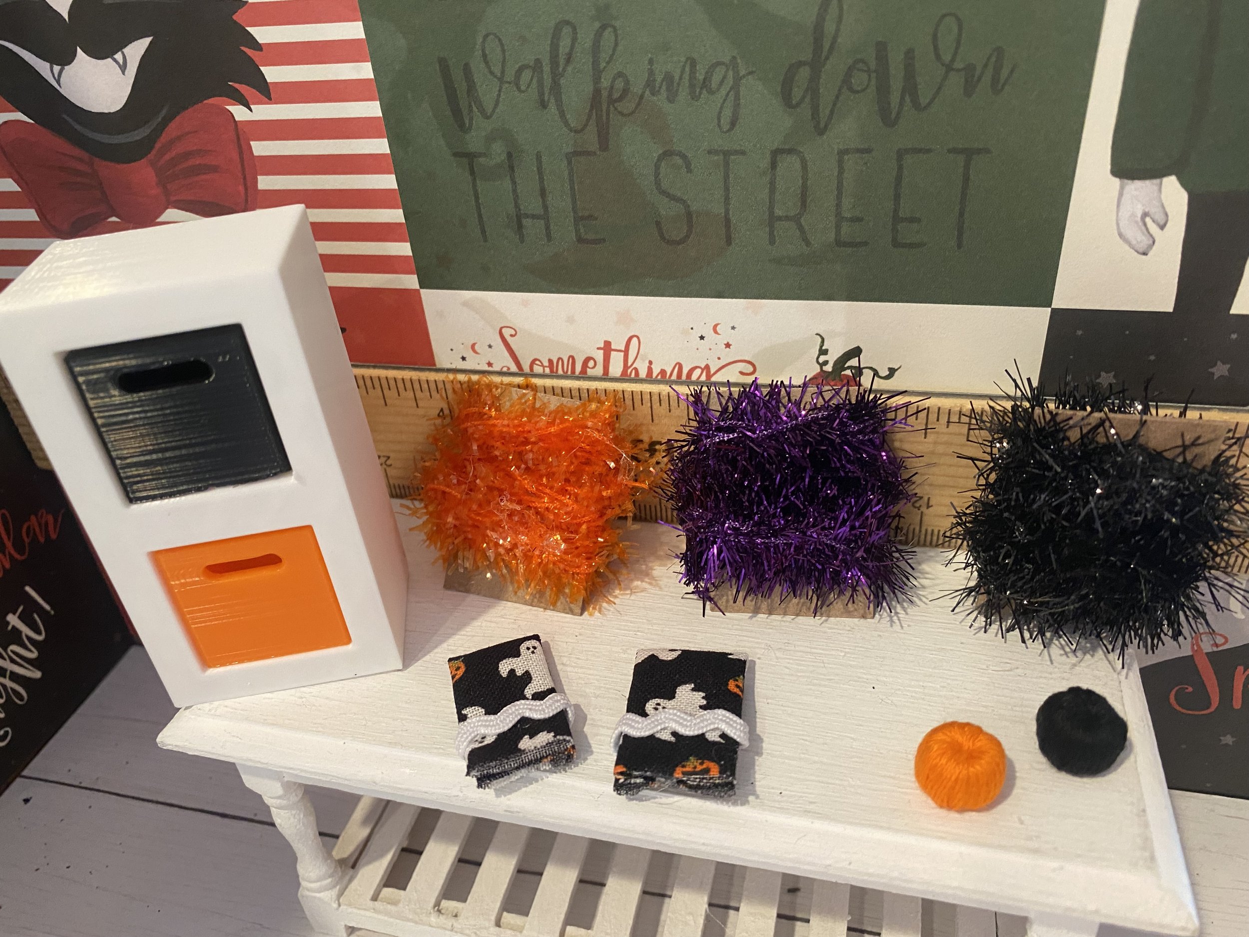 White Cubby w/Orange and Black Drawers, Orange, Black, Purple Tinsel Bolts. Orange and Black Yarn Cakes, Halloween Dish Towels, 1:12