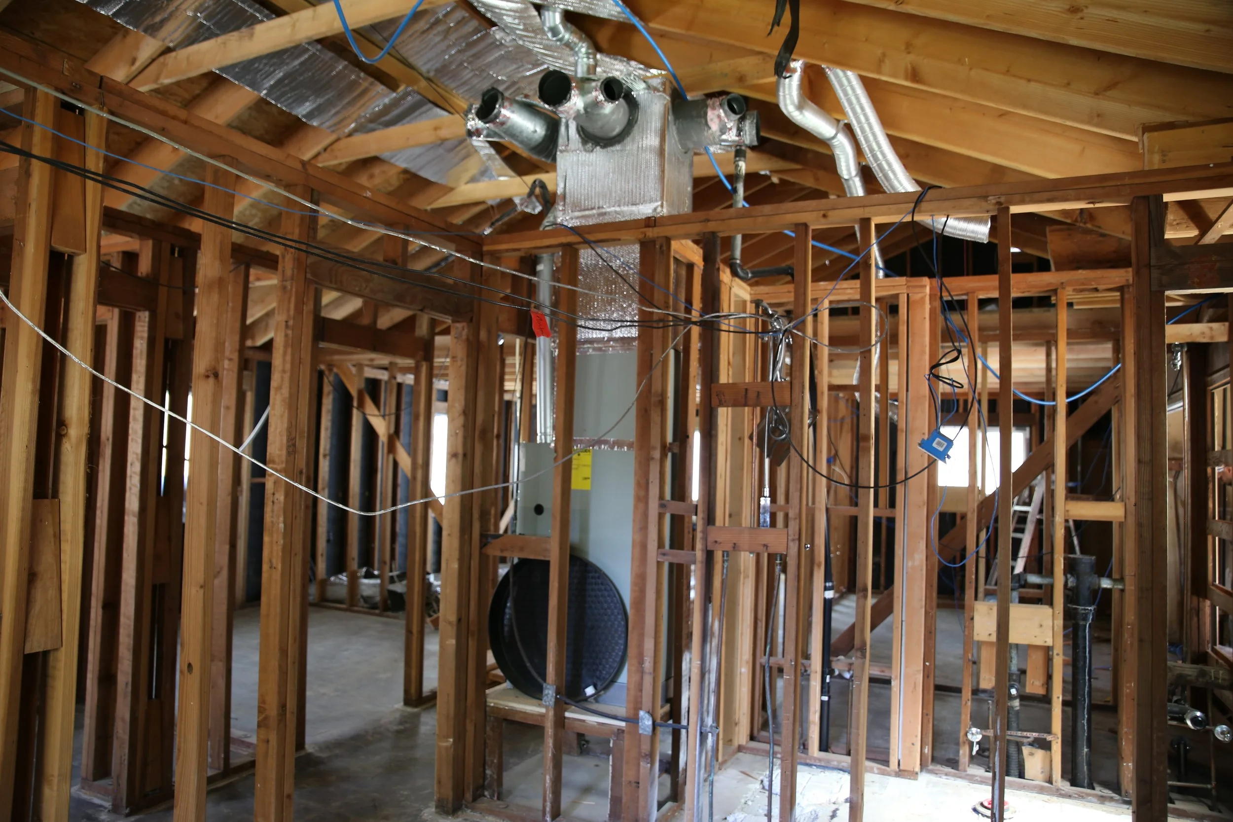High-end kitchen remodel in Vacaville showing rough-in electrical and plumbing before installation of custom cabinetry and designer finishes