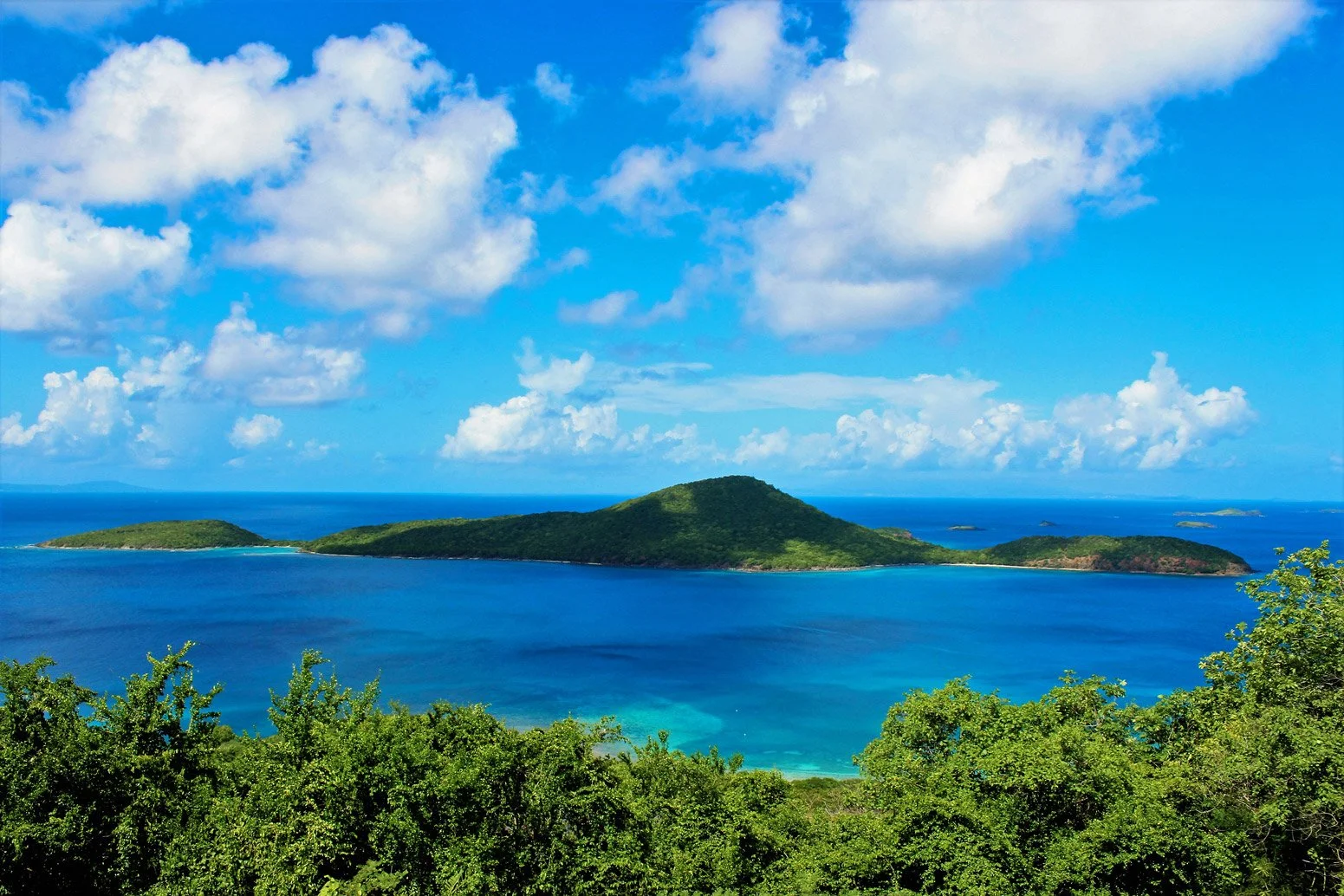 Lush green island of Culebra shown with clear blue skies and turquoise blue waters