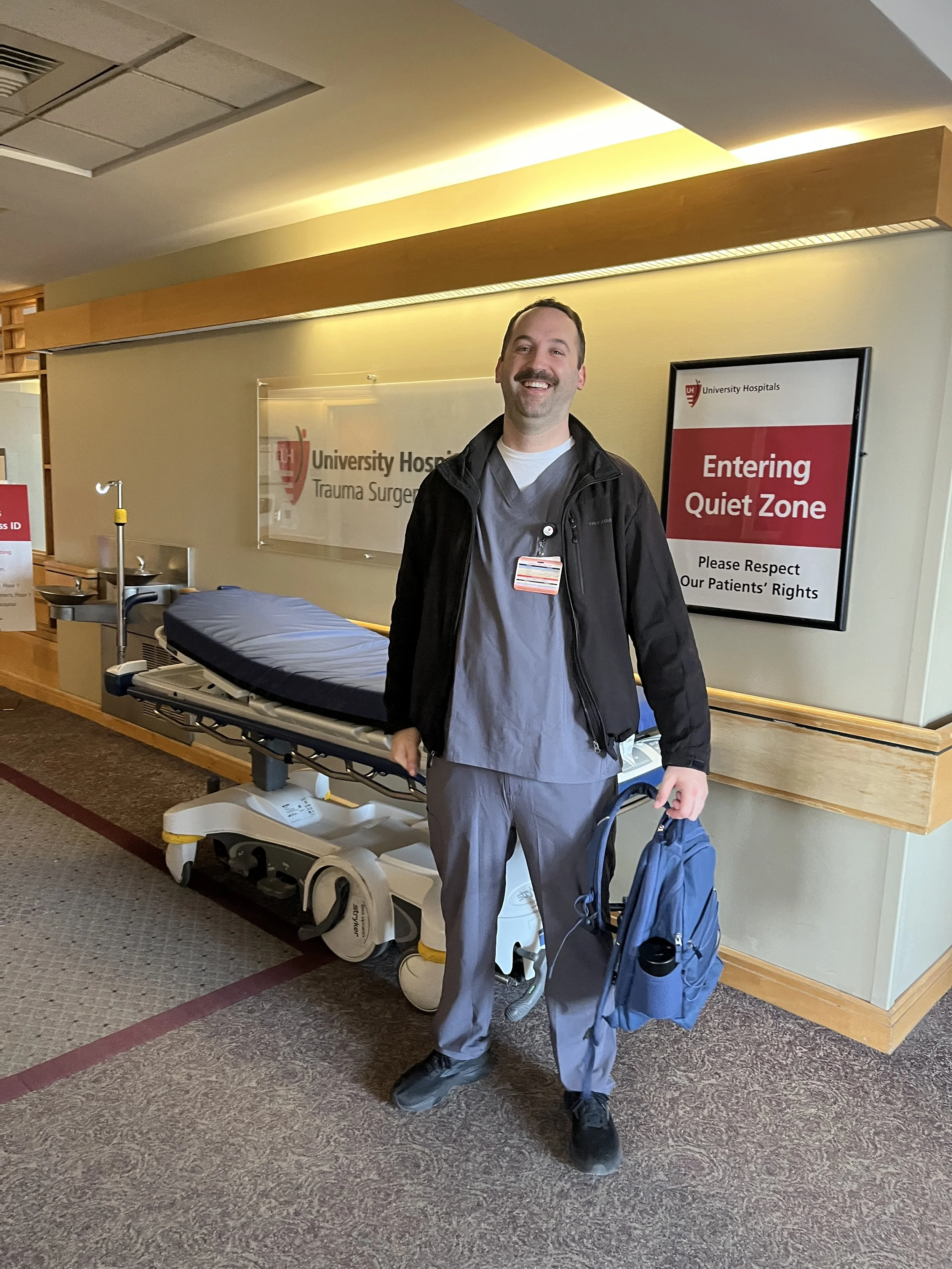 Kevin Lenahan in scrubs at University Hospitals, where he works part-time as a nursing assistant in trauma care.