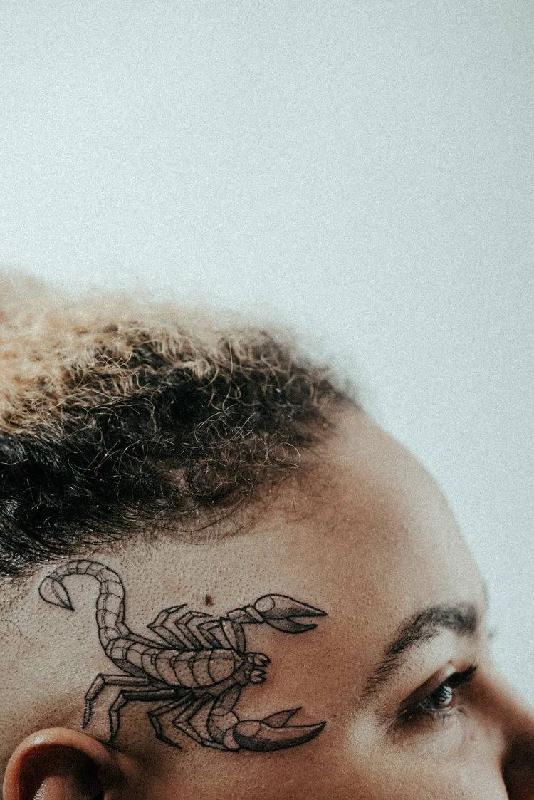 Scorpion tattoo on the side of the head