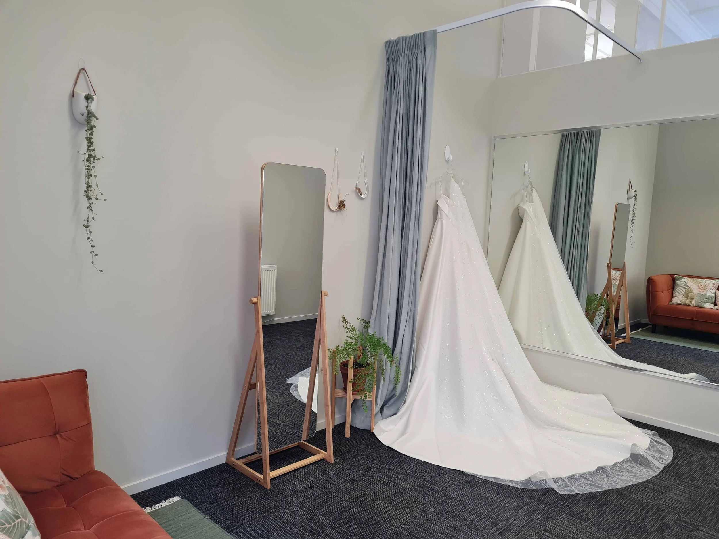 Wedding gown hanging in the private fitting room at Alena Hume, Palmerston North — ready for a bridal alteration appointment