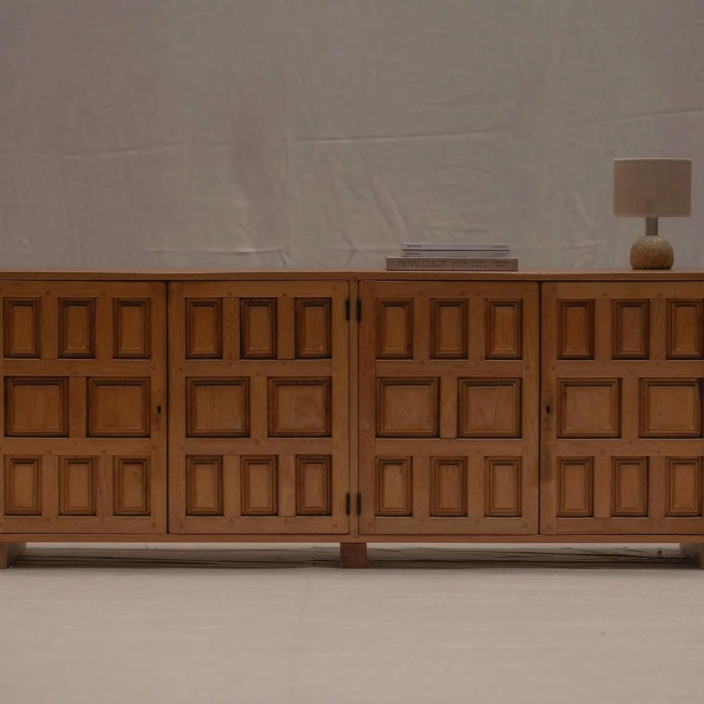 FOR SALE - A striking Brutalist sideboard from 1970s Spain, crafted in solid oak with a natural, light finish. The design is defined by its geometric paneling across the four doors, a hallmark of Spanish Brutalism, creating rhythm and depth in the fa