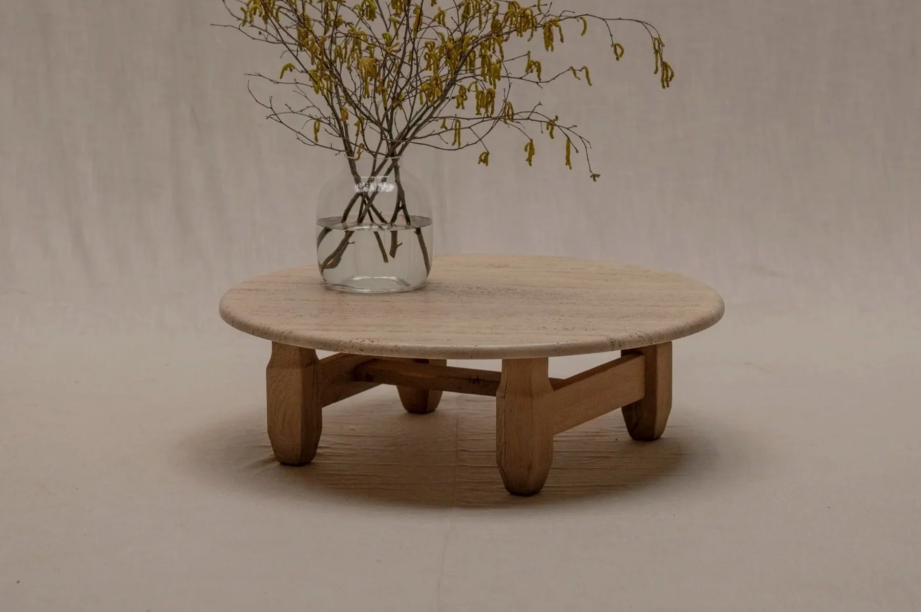 Brutalist round coffee table in travertine and oak, 1960s