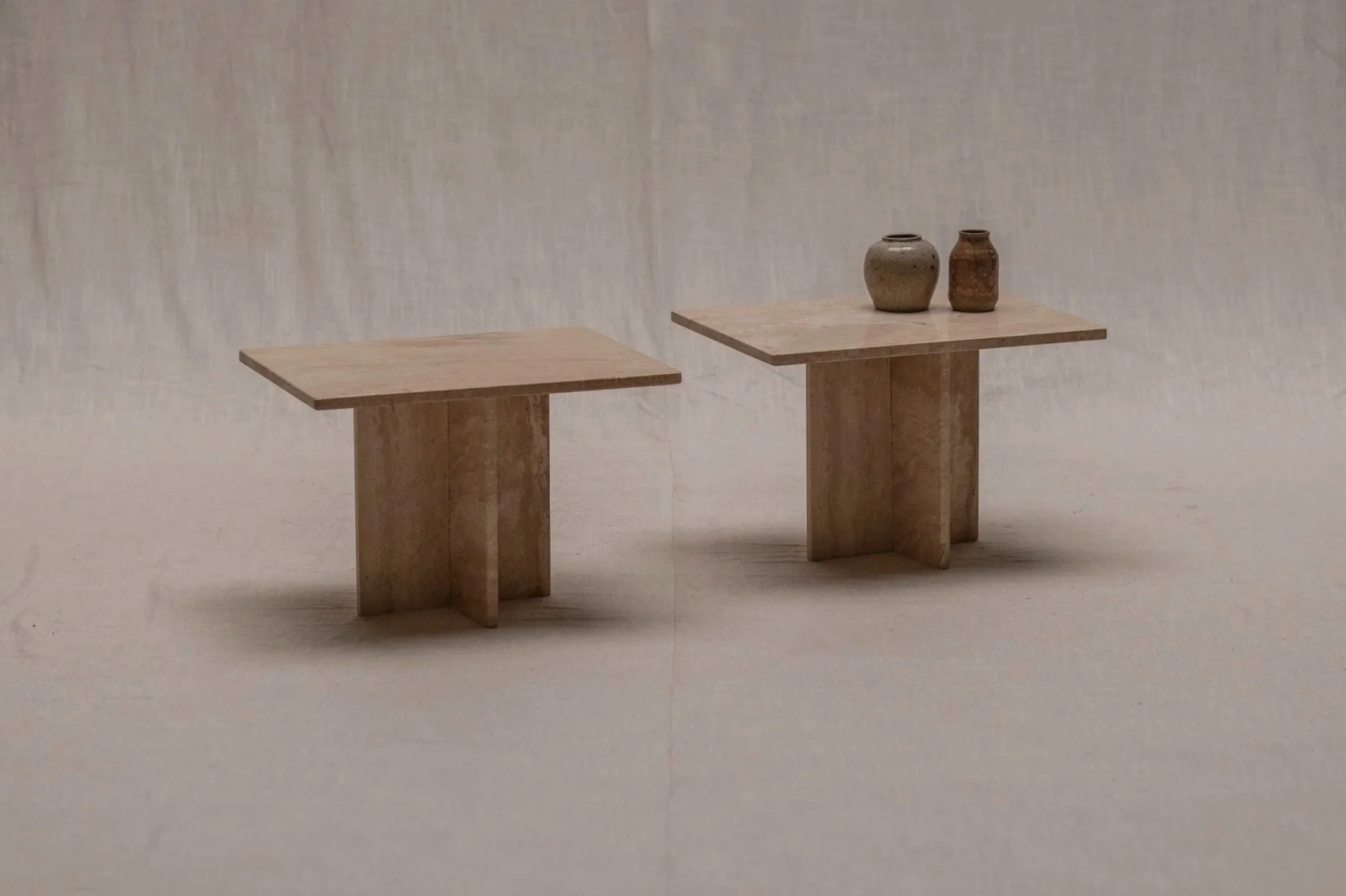 Set of two Italian travertine side tables, 1970s.