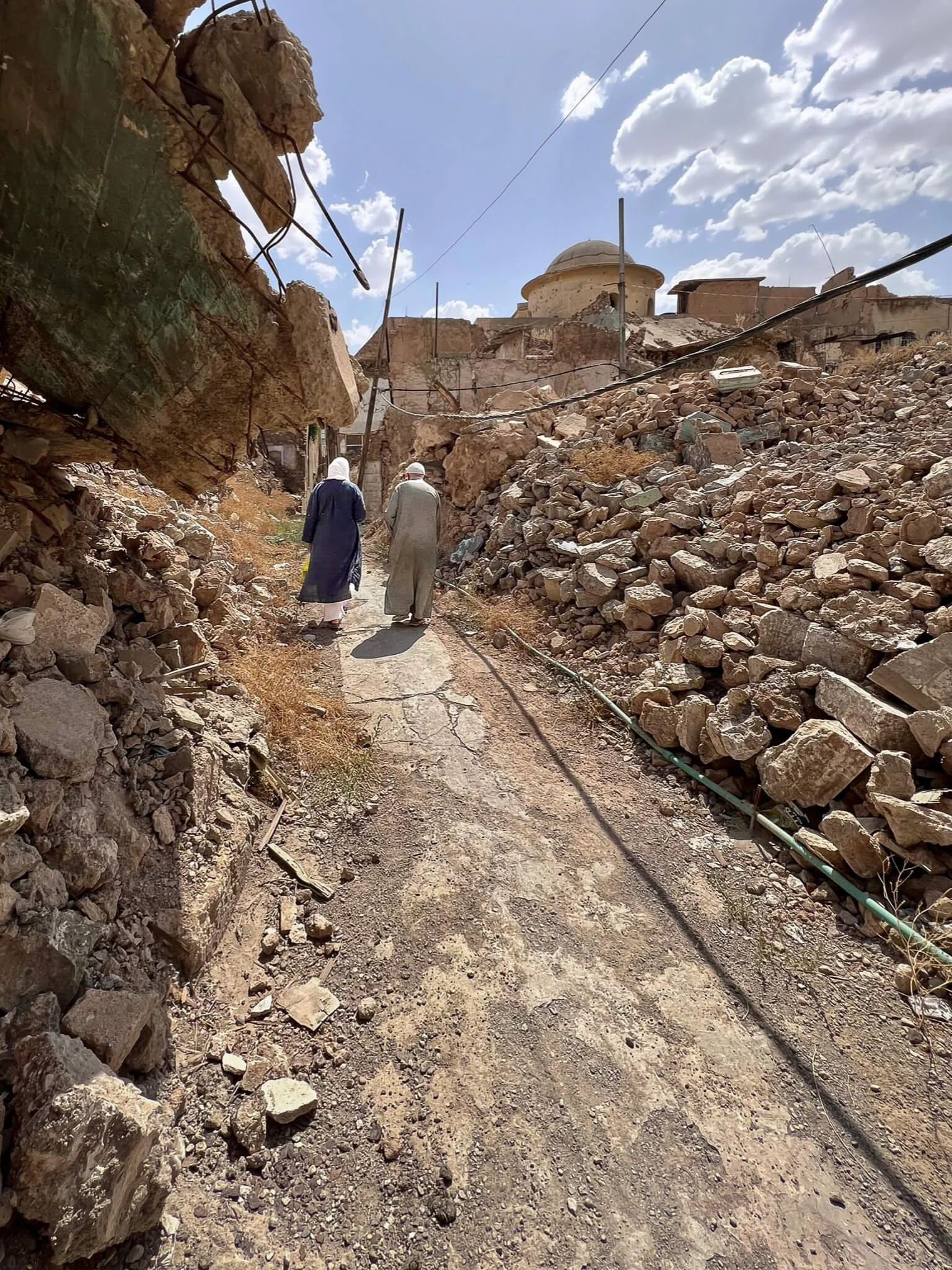 Surveying the ruins.
