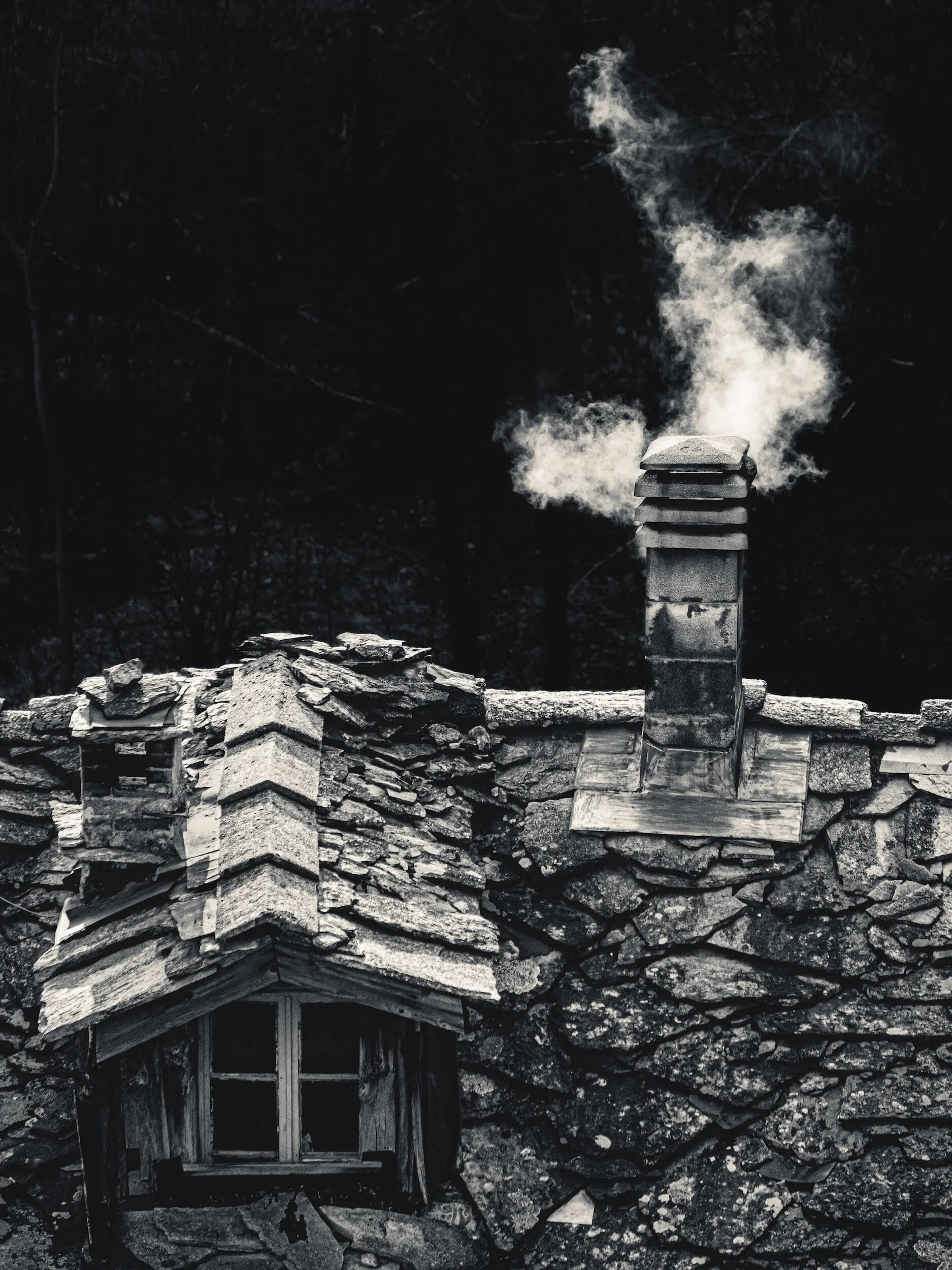 Woodfire smoke from alpine house chimney 