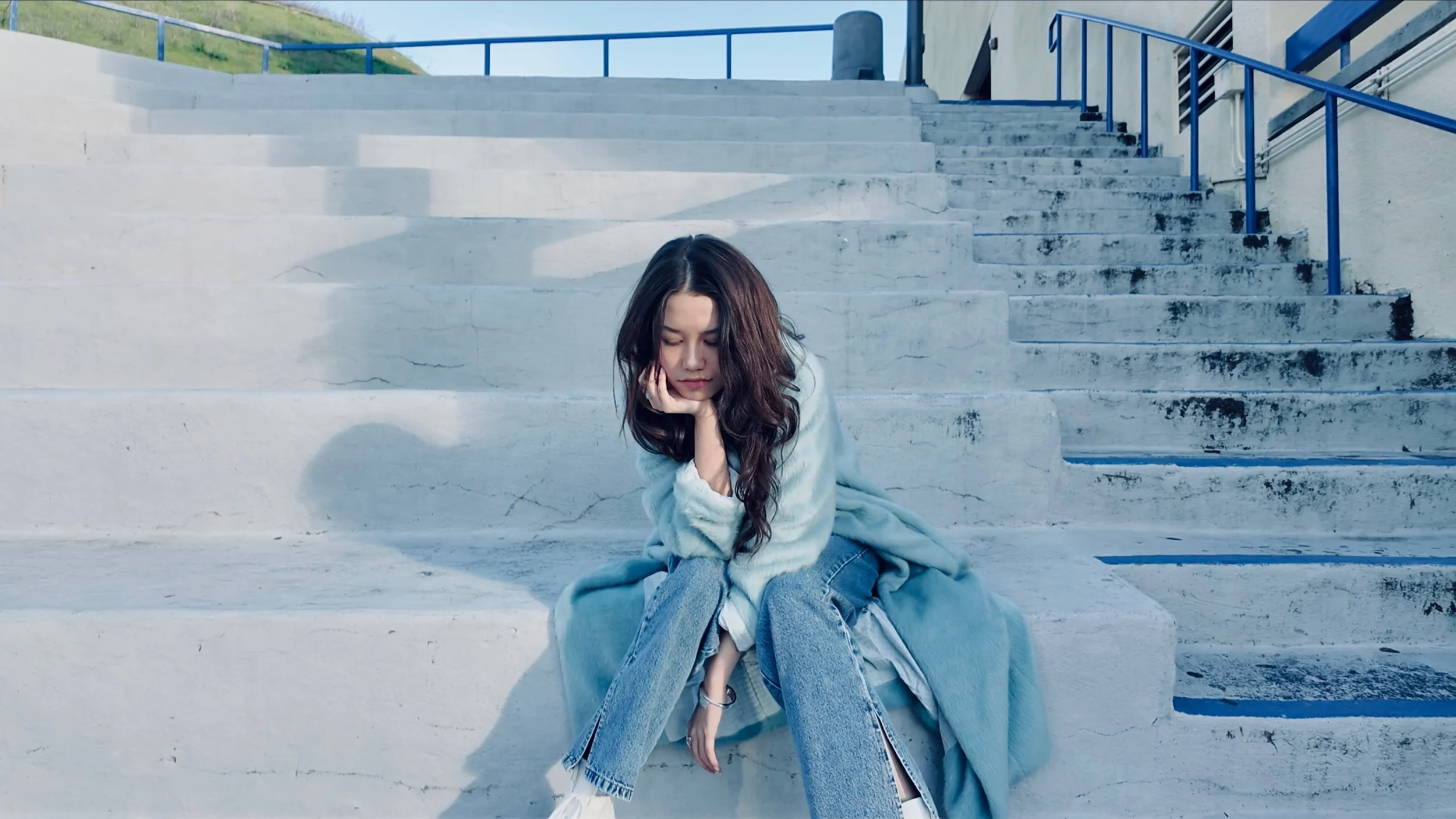 Trinity Bliss sitting on outdoor steps