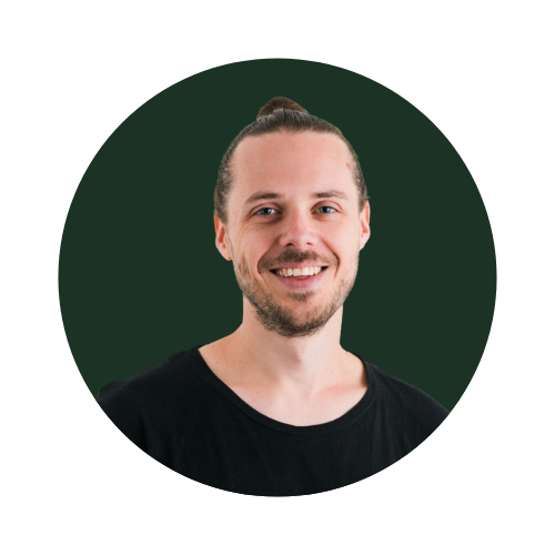 Rich Webster, How To Work Less Owner, Man smiling with a bun hairstyle wearing a black shirt, green background.