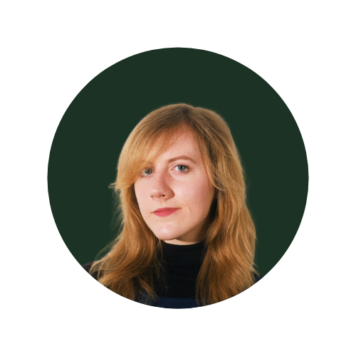 Sophia Babb, owner of Dream Scale, Portrait of a woman with long blonde hair against a dark green background.