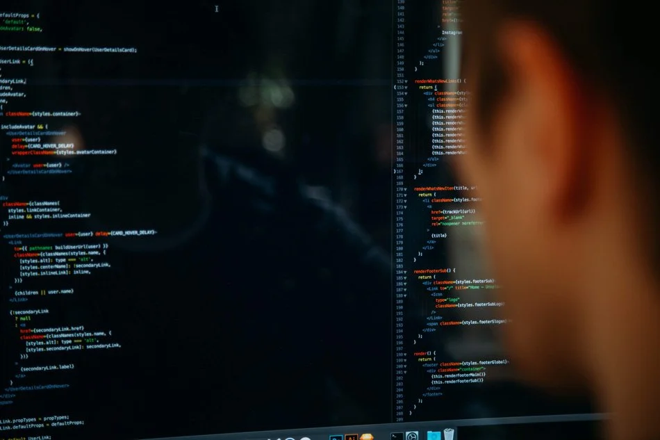Person viewing a computer screen with code, likely web development or programming code.