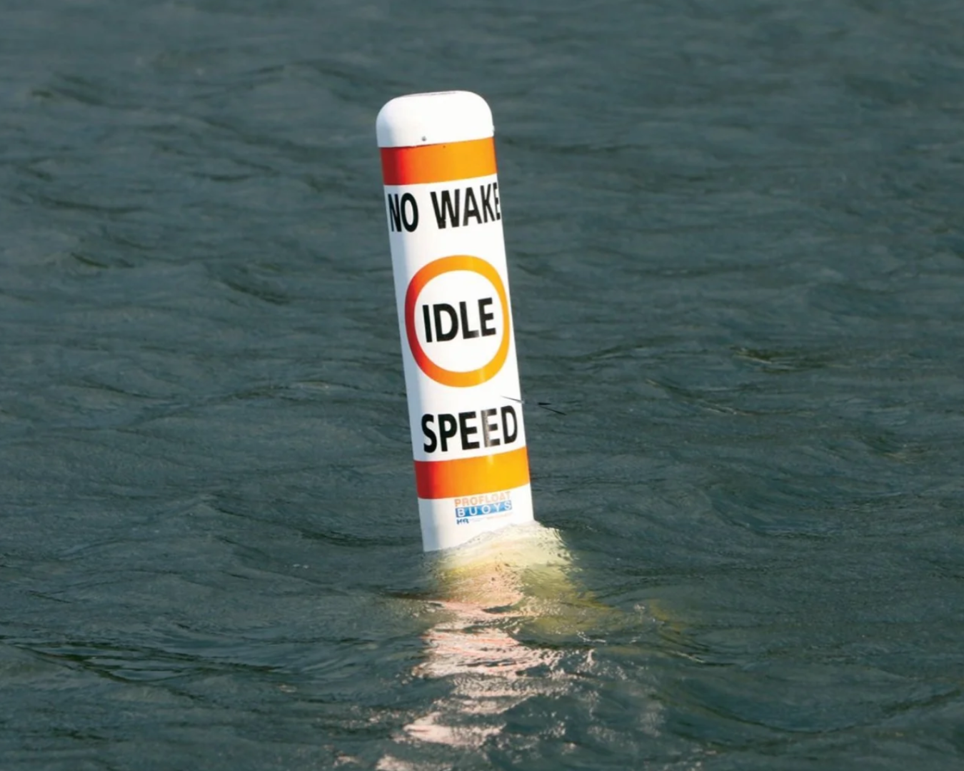 Floating regulatory buoy marking no wake idle speed zone for marina and waterway safety by K+R Manufacturing