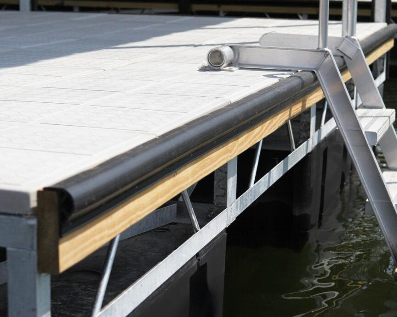 ProGuard vinyl dock edging installed along floating dock edge for boat hull protection by K+R Manufacturing