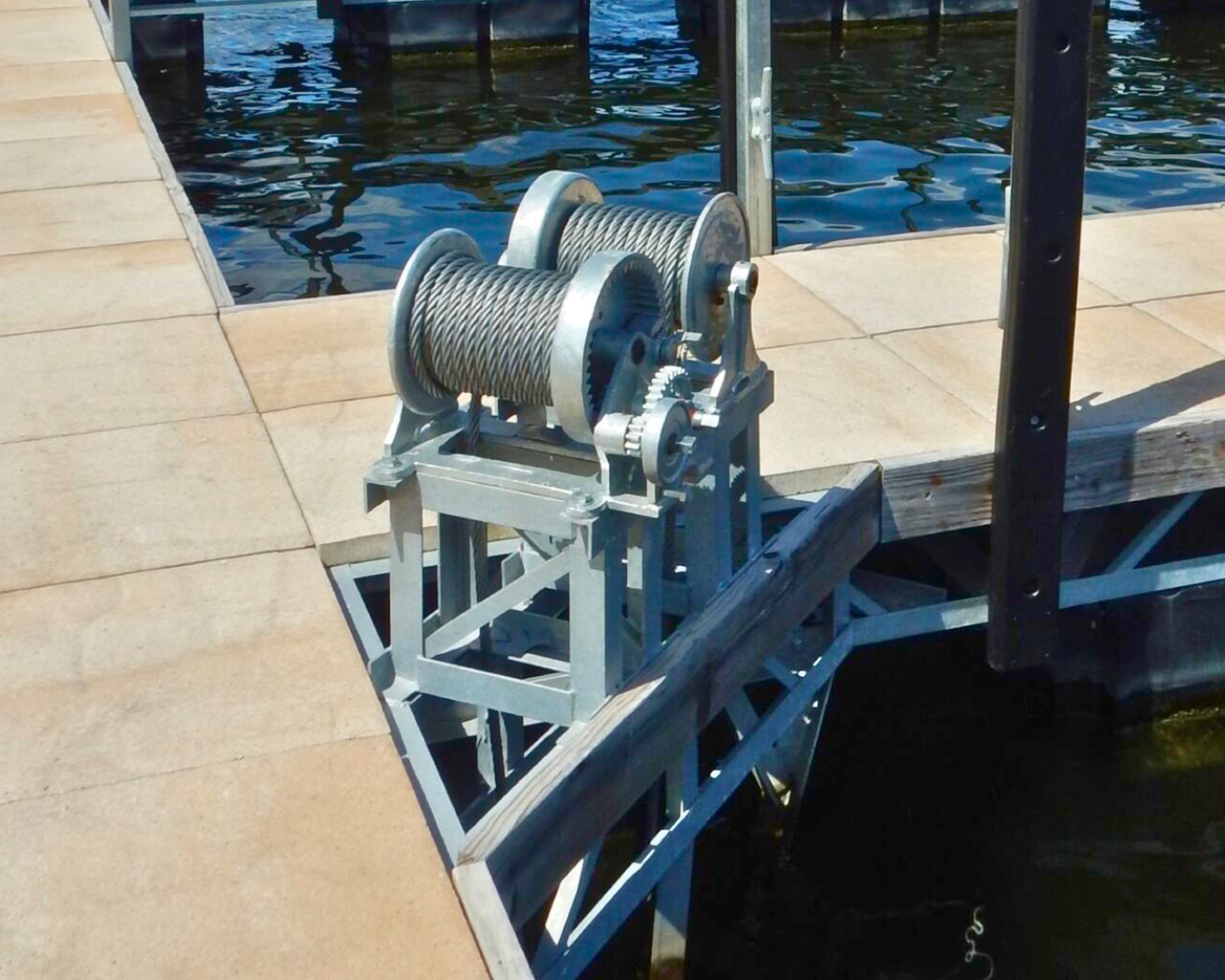 Heavy-duty dock winch with galvanized cable installed on boat lift for raising and lowering boats by K+R Manufacturing