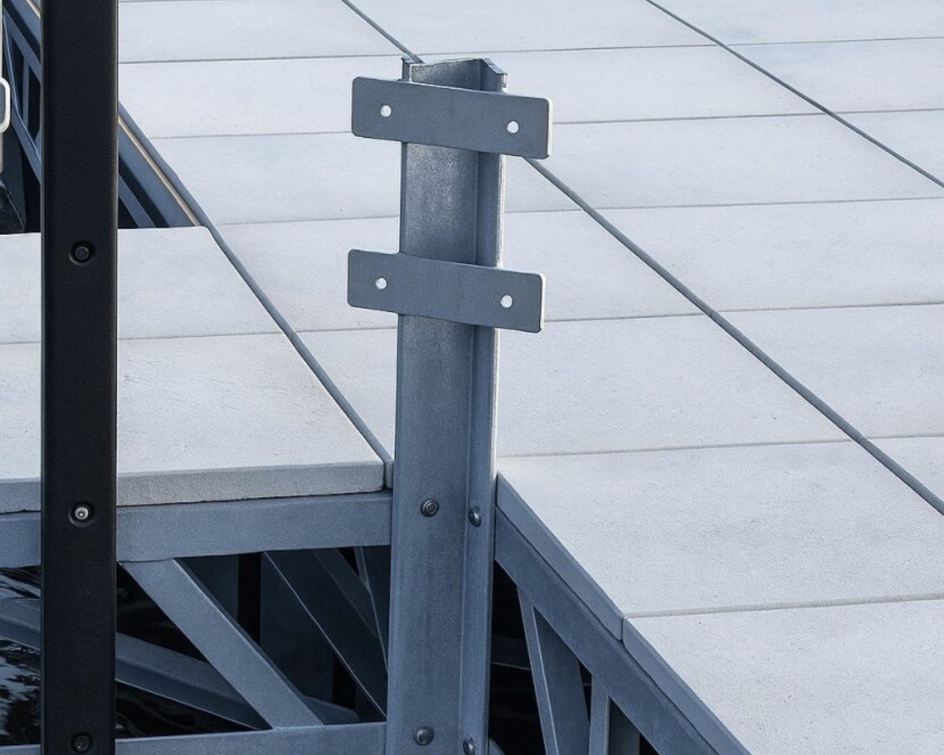 Universal dock winch stand mounted on floating dock frame for supporting boat lift winches by K+R Manufacturing