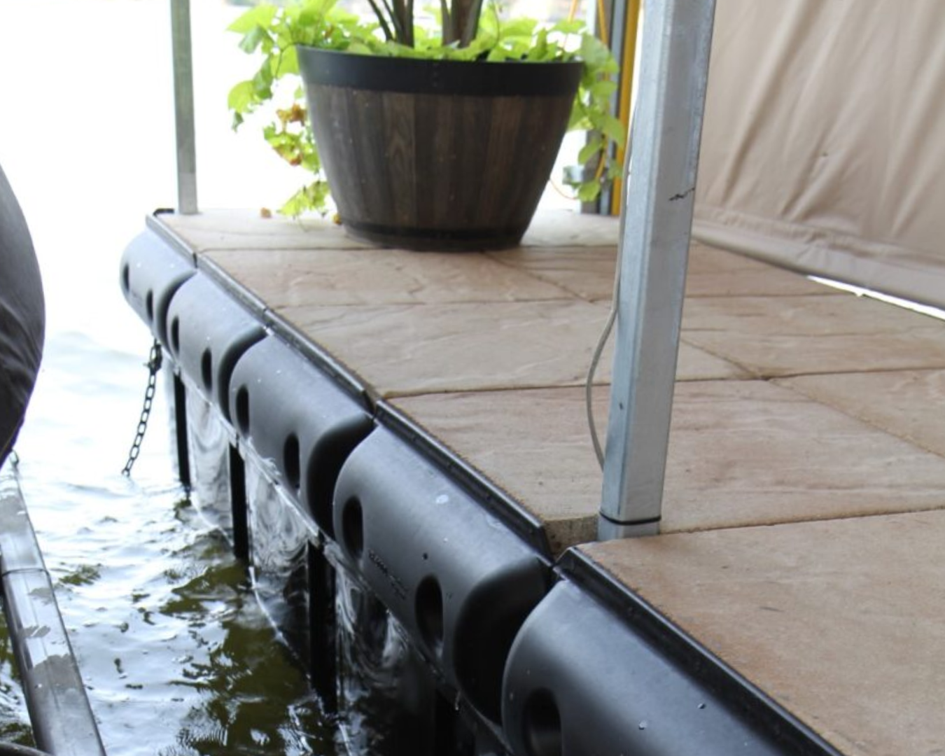 CruiserCushion dock bumper installed along floating dock edge for boat impact protection by K+R Manufacturing