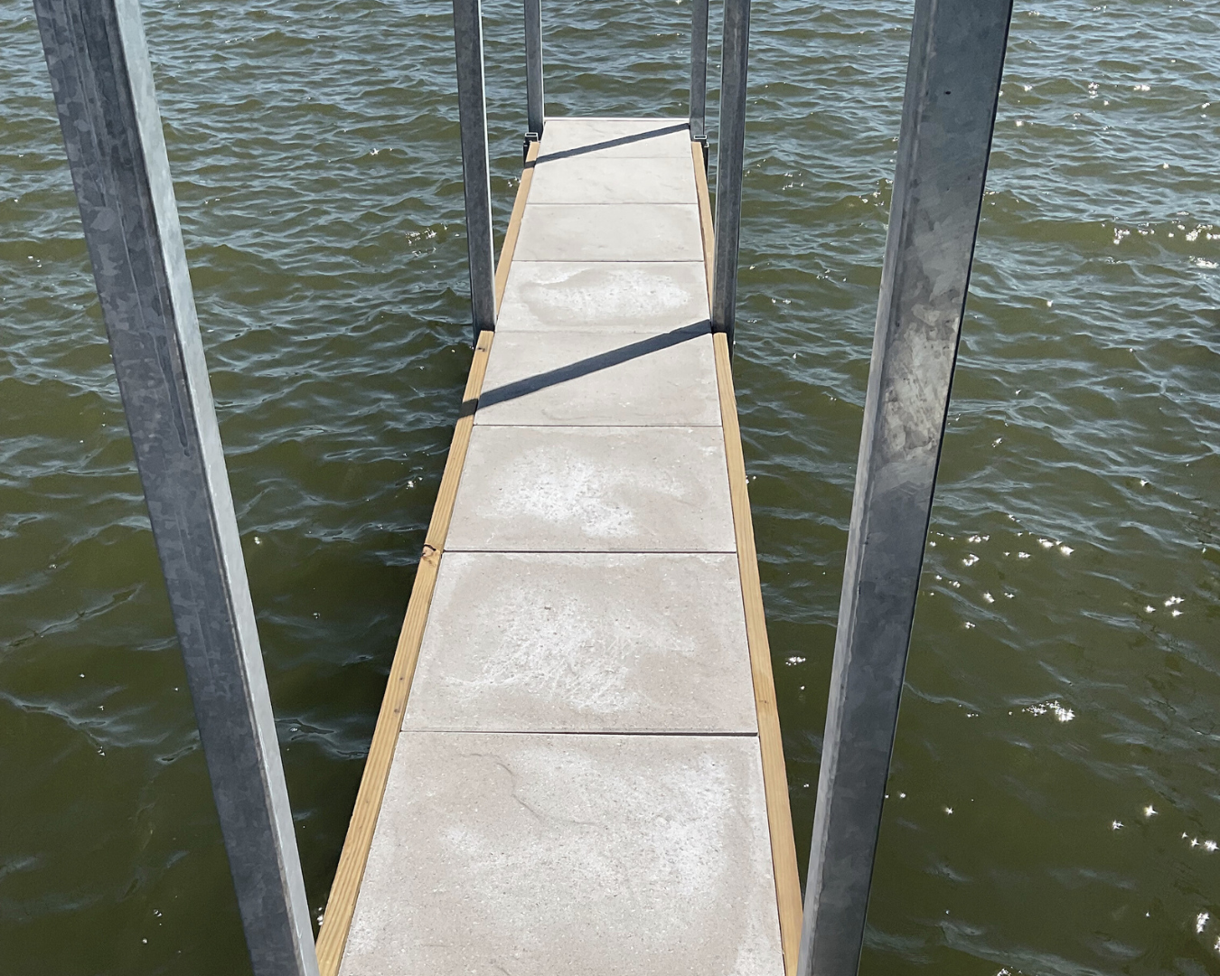 RockFace Evolution concrete dock decking installed on narrow marina walkway by K+R Manufacturing