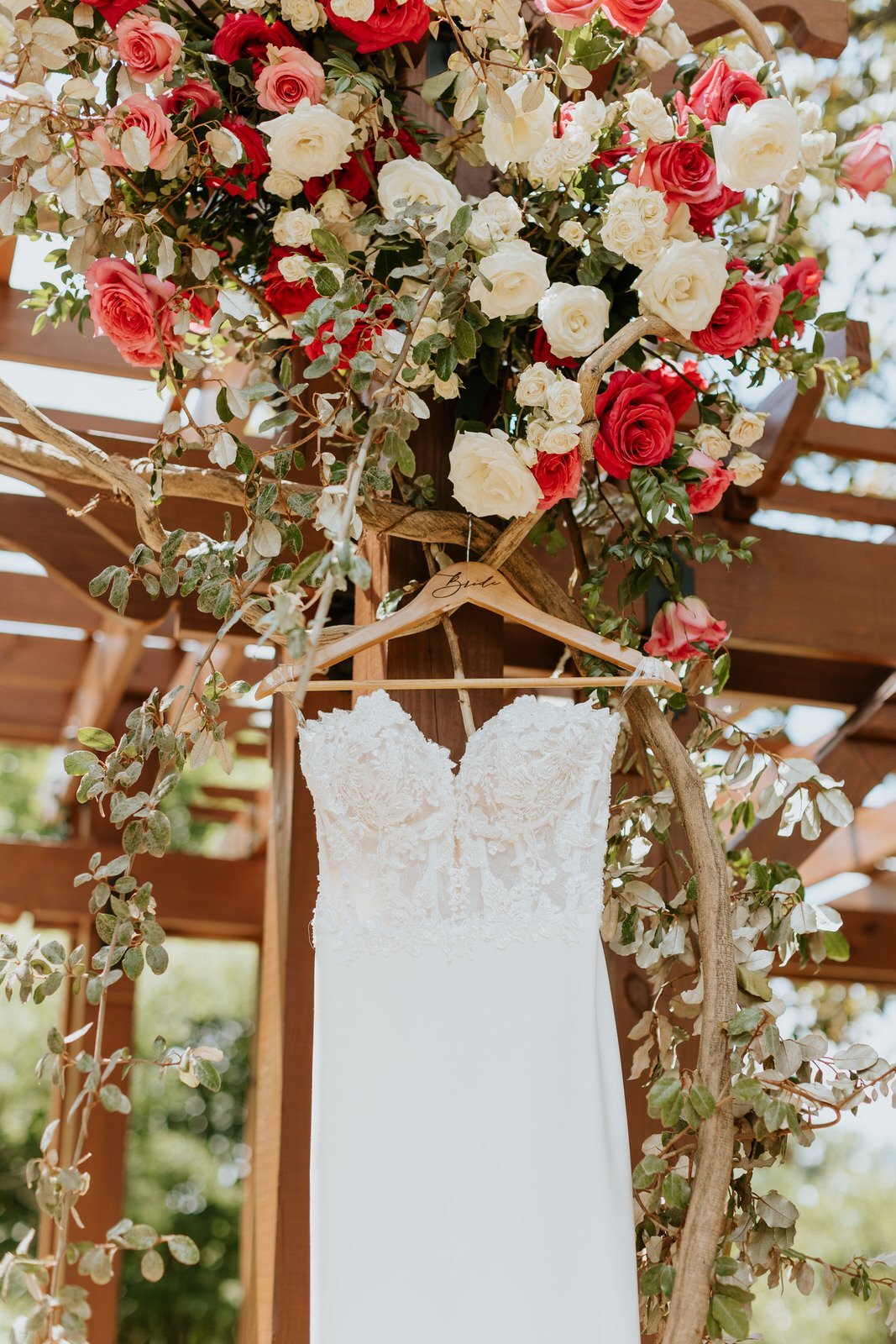 wedding dress hanging by flowers