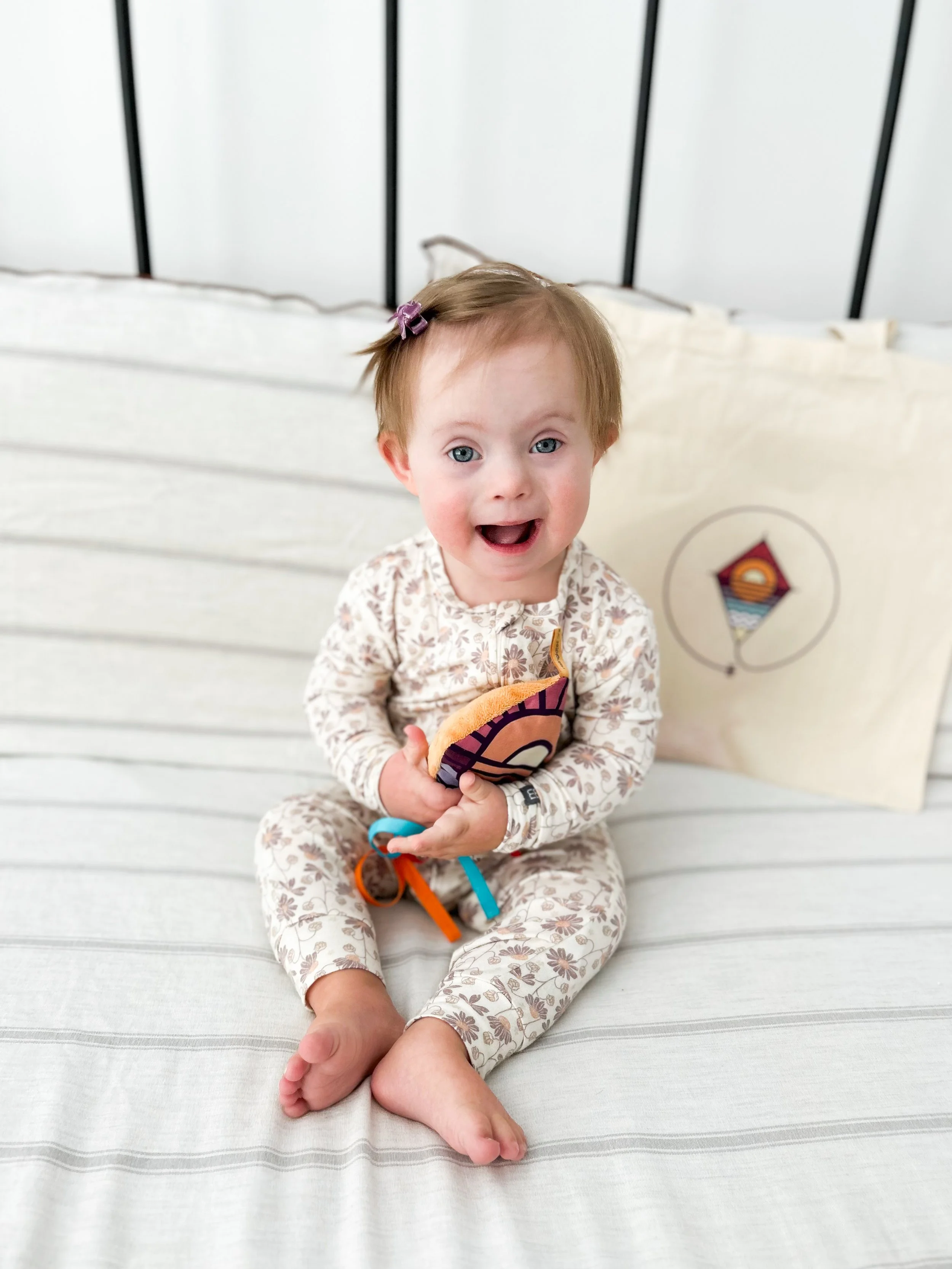 Child with Down syndrome with a Rising Kites resource bag