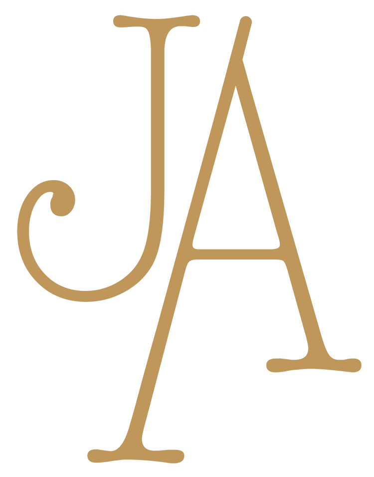 Stylized golden letters J and A overlapping on a black background.
