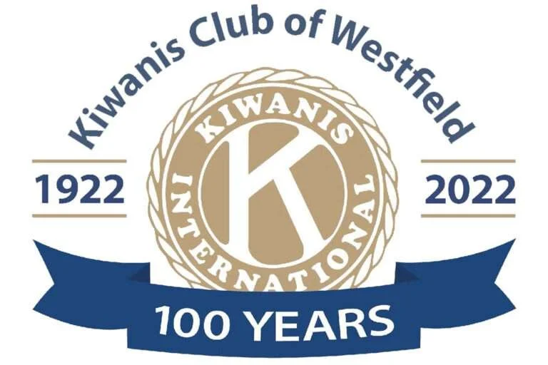 Logo of Kiwanis Club of Westfield celebrating 100 years, from 1922 to 2022, with a gold emblem featuring a large 'K' in the center, encircled by the words 'Kiwanis International' and a blue ribbon stating '100 Years'.