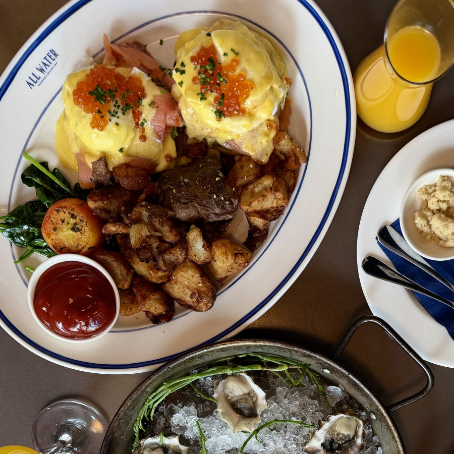 All Water Seafood & Oyster Bar Eggs Benedict Royale with salmon lox, poached eggs, smashed avocado, hollandaise, salmon roe and chives