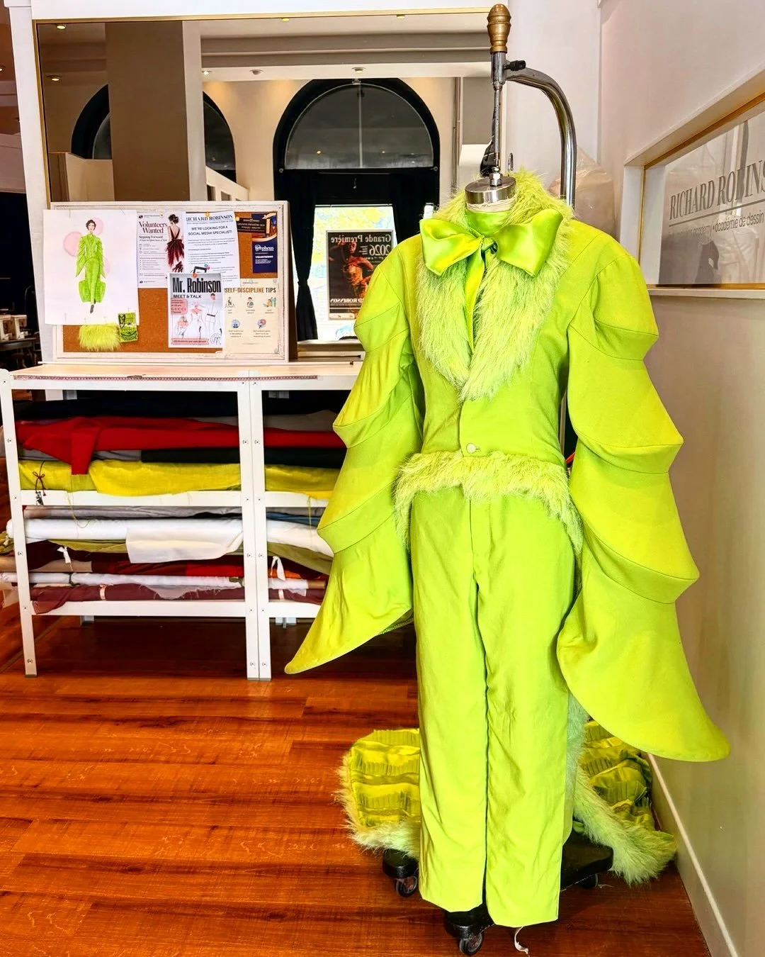 Inspired by Oscar Wilde. Designed by Tessa Trahan, a second year fashion design student.
 
Featured in our History of Fashion showcase at Grande Premiere 2026, this bold lime green creation pairs sculptural sleeves, textured trim and an oversized bow