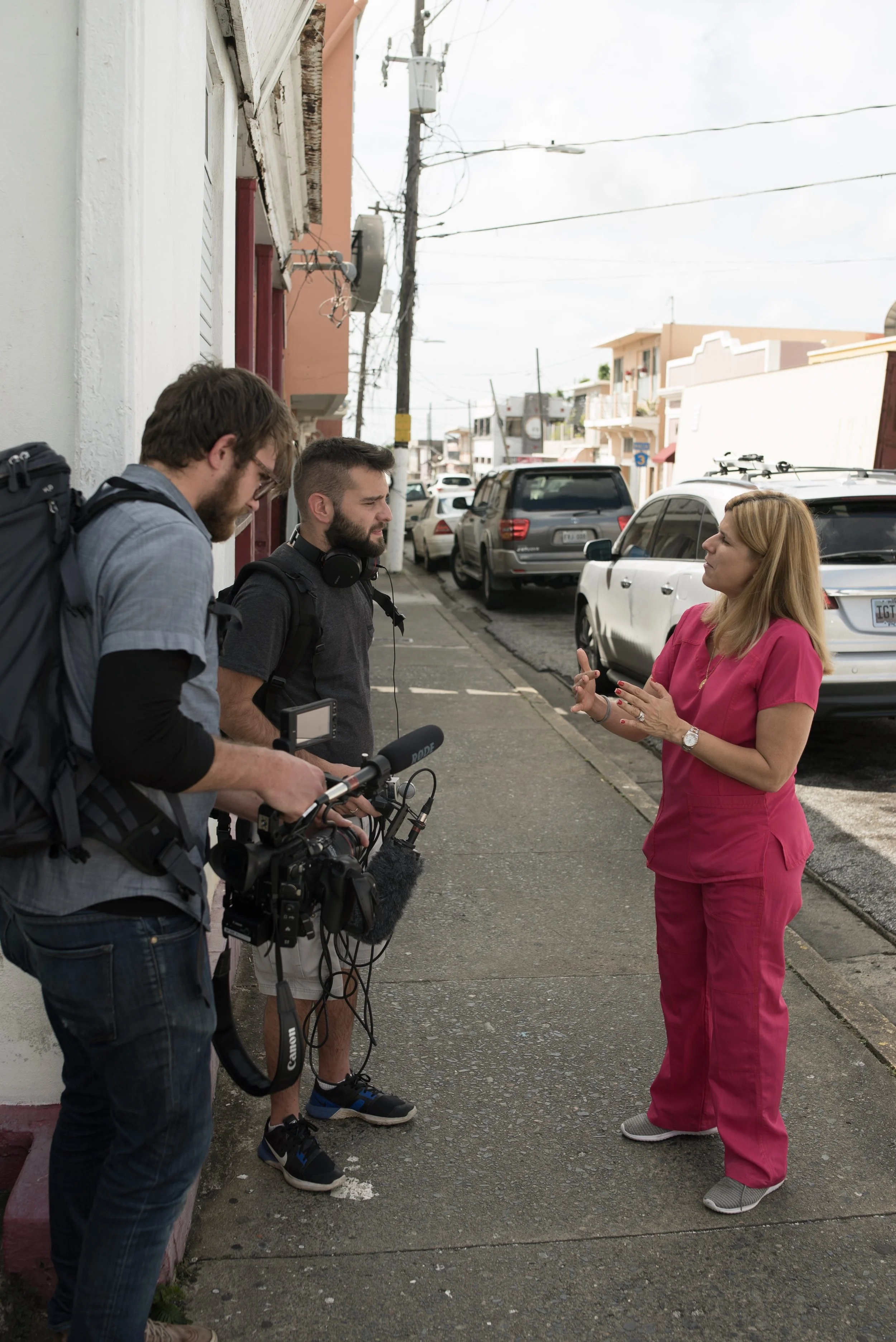 Behind the scenes: director Sam Menendez and Elias Jessop filming an interview with Rita Suez for Hurricane Maria: Stories from the Storm, produced by Annie Menendez