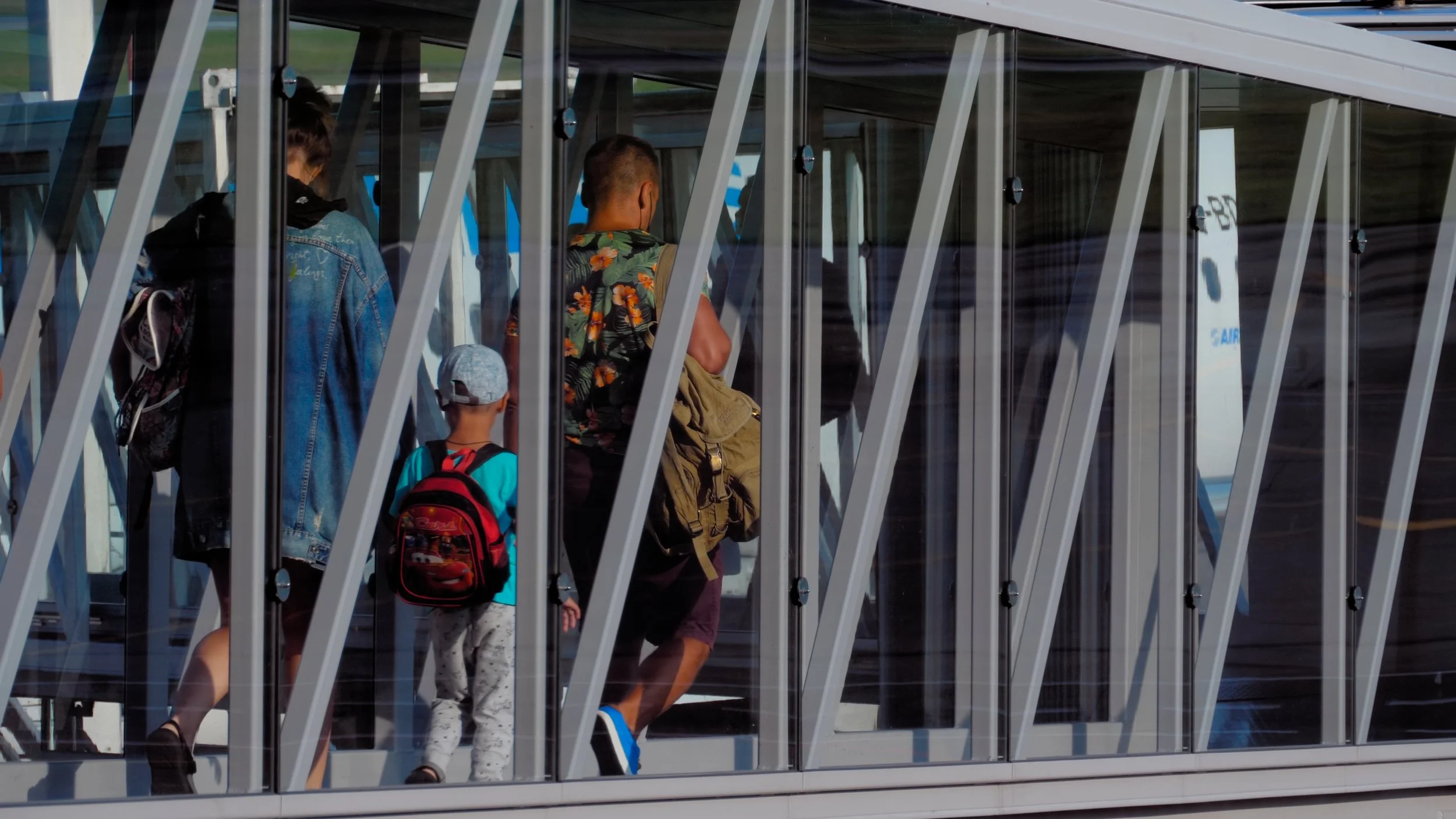 Commuters crossing a covered pedestrian bridge. Still from Priced Out of Paradise, a Hawaii housing documentary directed by Annie and Sam Menendez