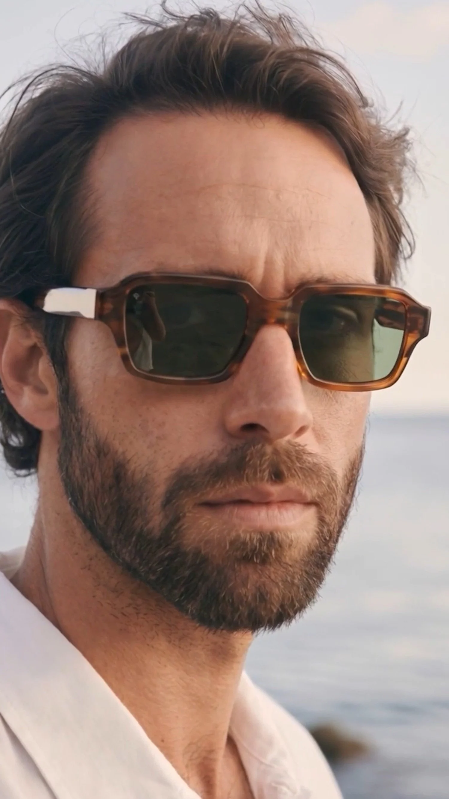AI Productions by Apollo Studios: man in tortoiseshell sunglasses from an AI commercial