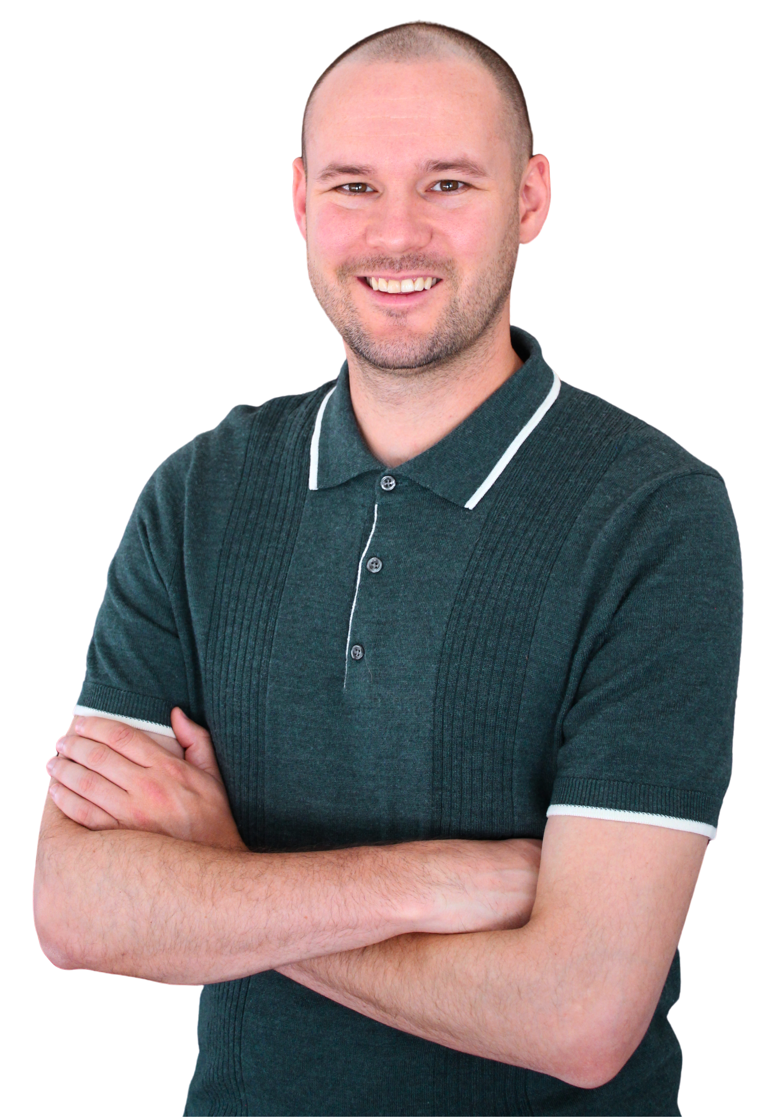 Chris Canales, wearing a dark green polo shirt with white trim, standing with arms crossed.
