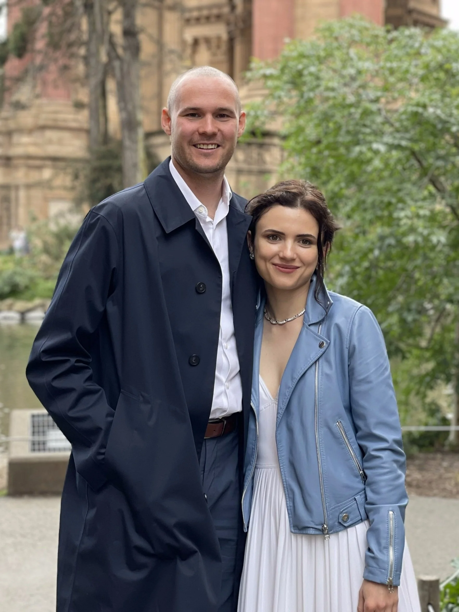 Chris and Nora posing for a photo on their wedding day.