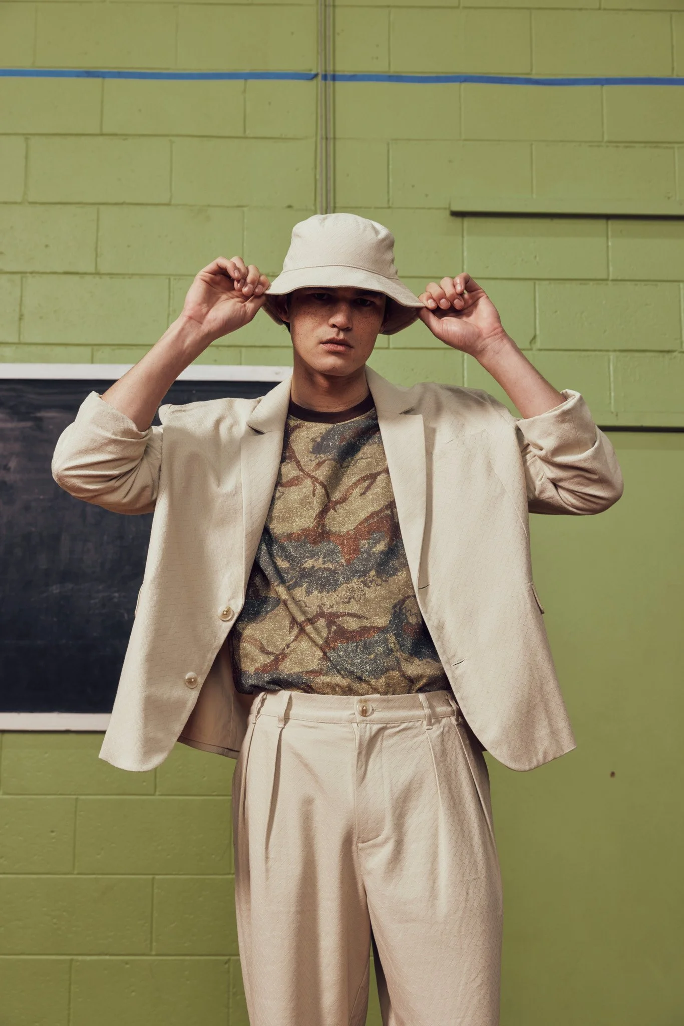 off-white-suit-mens-pleat-front-pant-manaaki-the-landing-camo-bucket-hat-ss26.jpg
