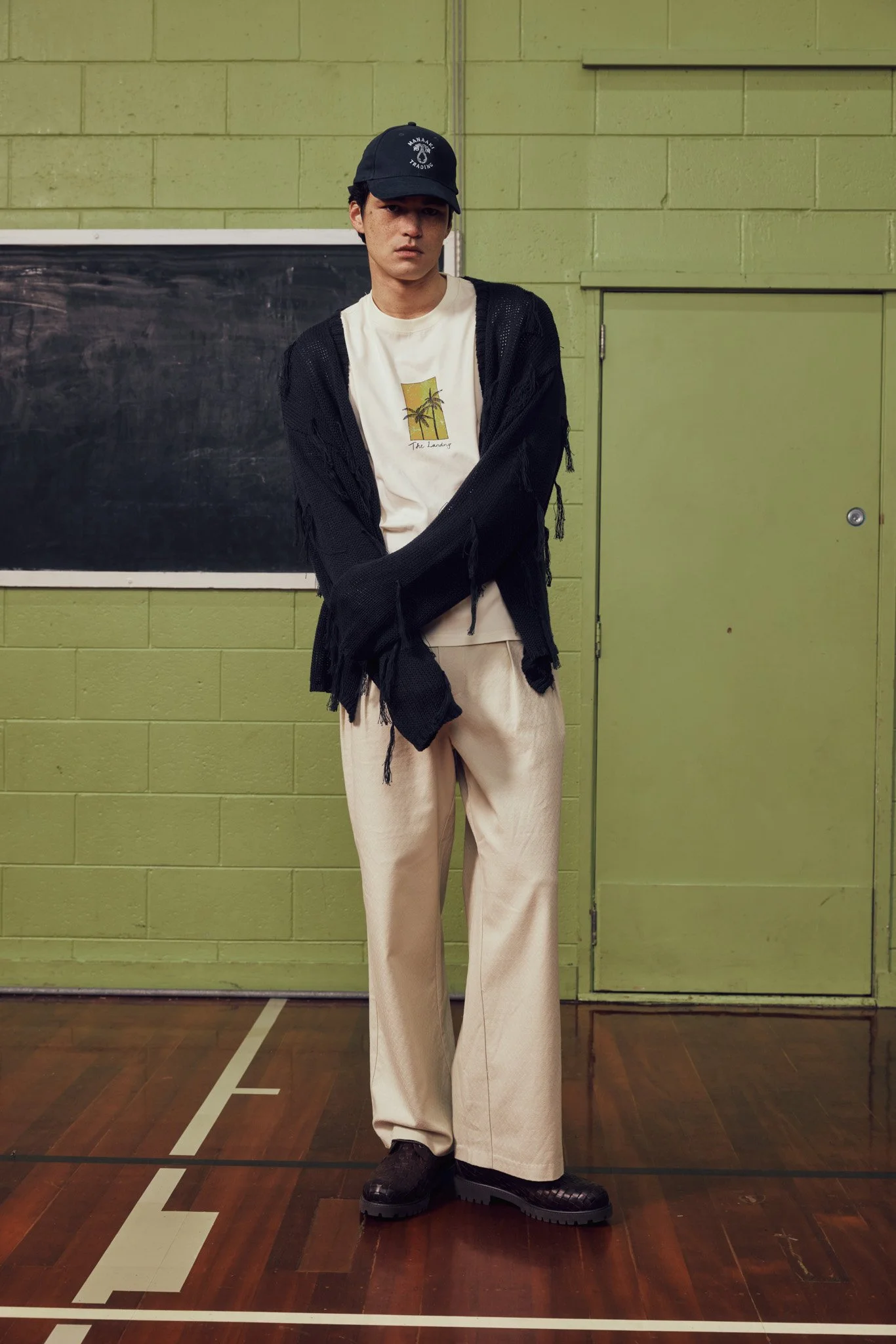 navy-white-tshirt-mens-cardigan-fringe-manaaki-the-landing-cap-logo-hat-ss26.jpg
