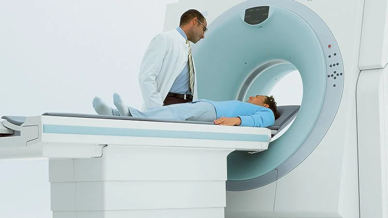 Doctor inspecting a patient during a CT scan in a medical facility