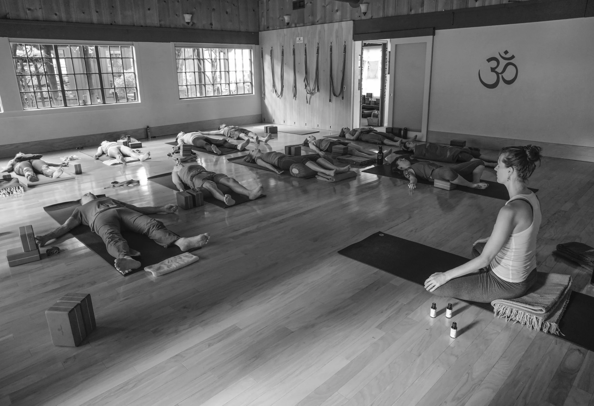 People in Savasana practicing Yoga Nidra and Restorative Yoga