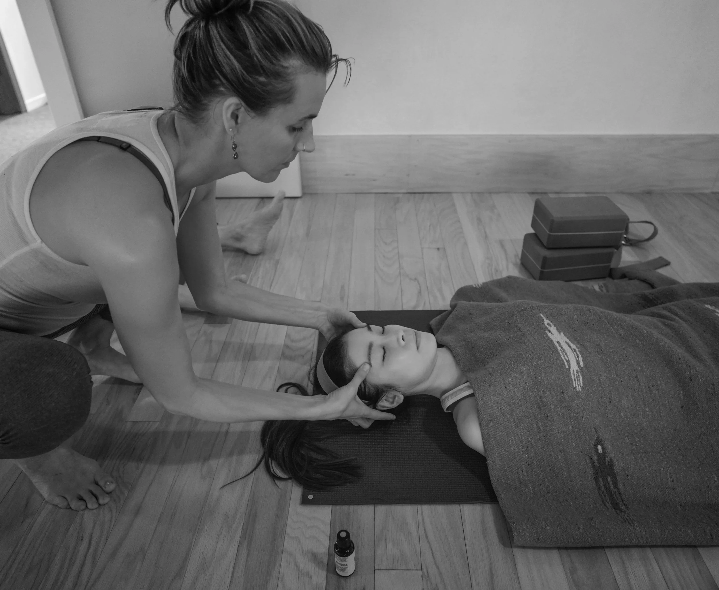 Cheri applying aromatherapy in Savasana. Hatha Yoga with optional Aromatherapy.