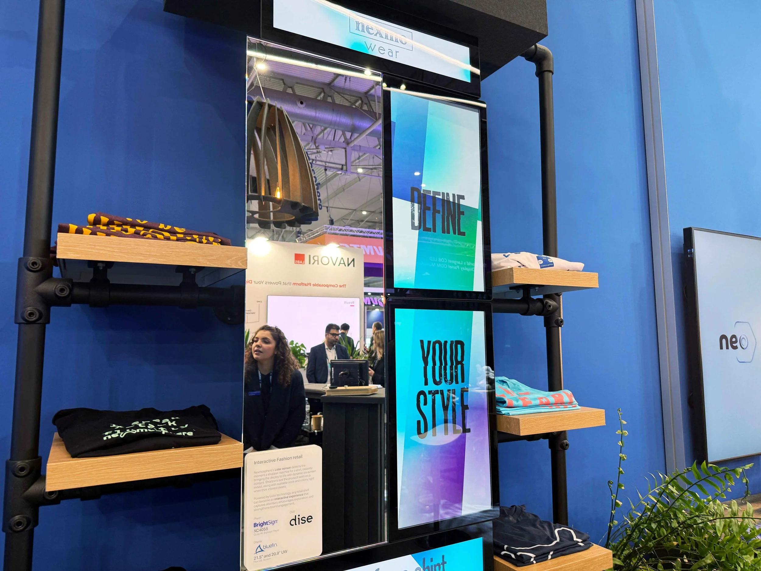 Bluefin vertical portrait displays integrated into a custom retail mirror for apparel branding.