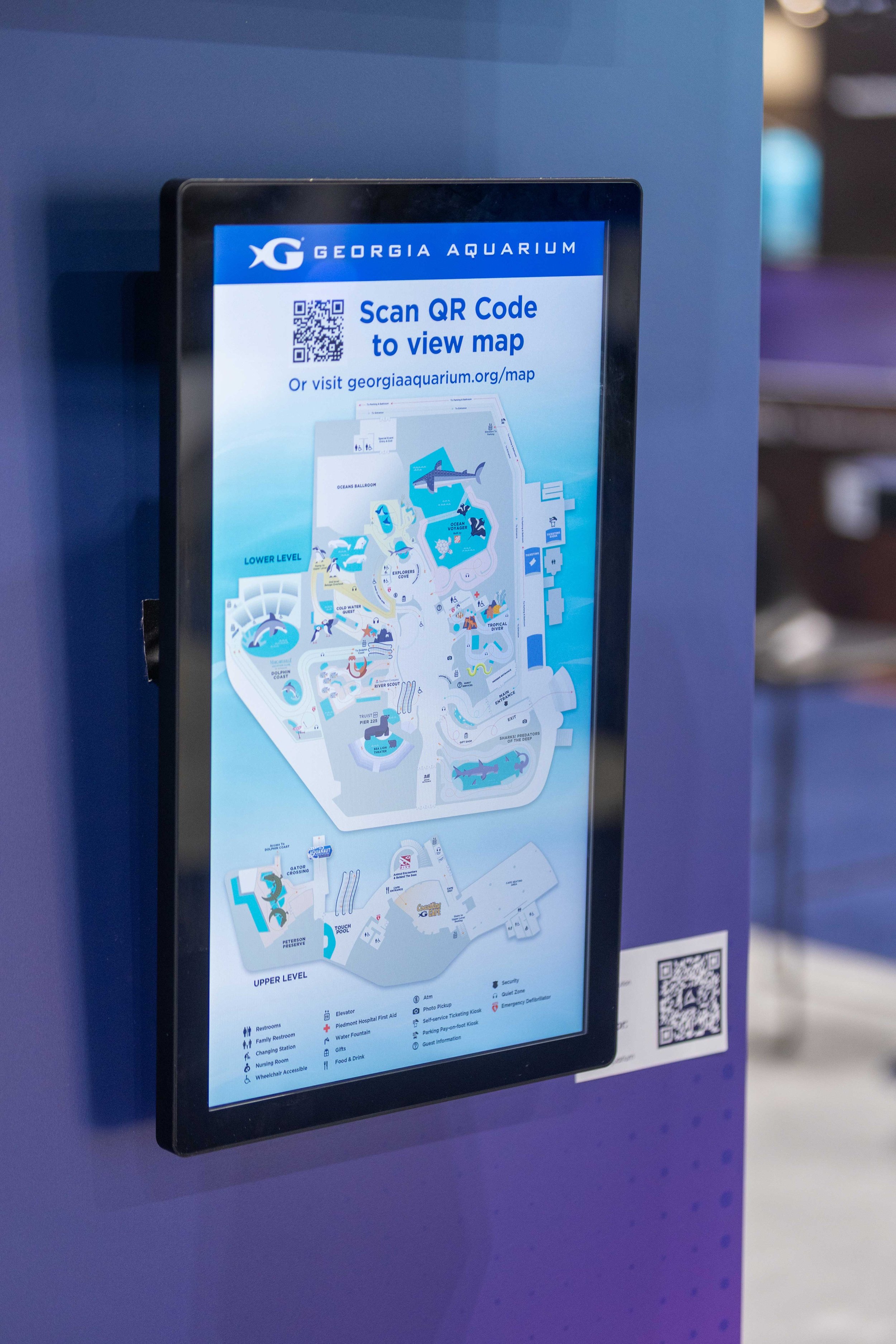 Bluefin digital touch screen displaying an interactive map and QR code for transit station navigation.