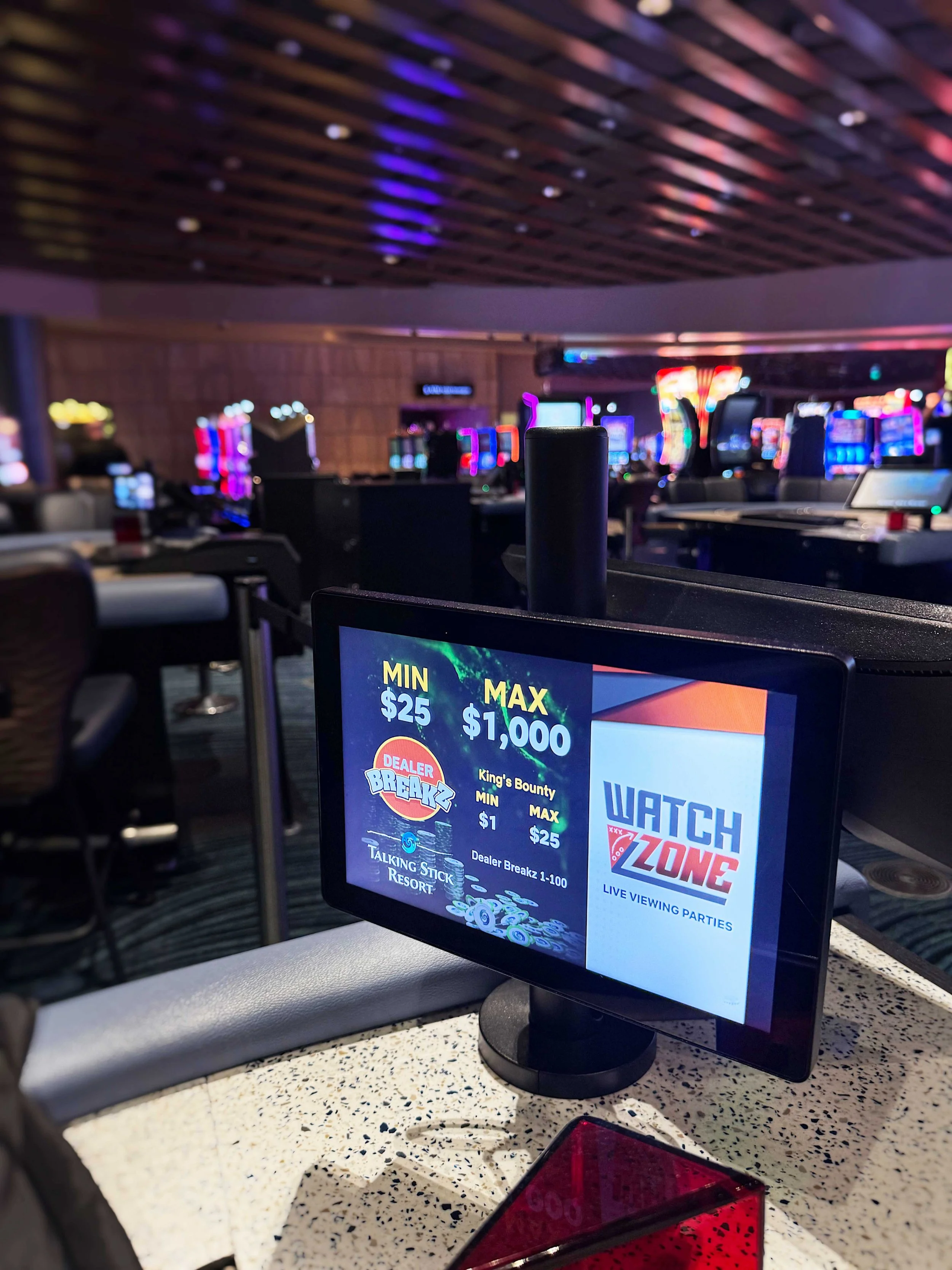 A close up view of a casino table game setup showcasing player tracking and table limit display areas
