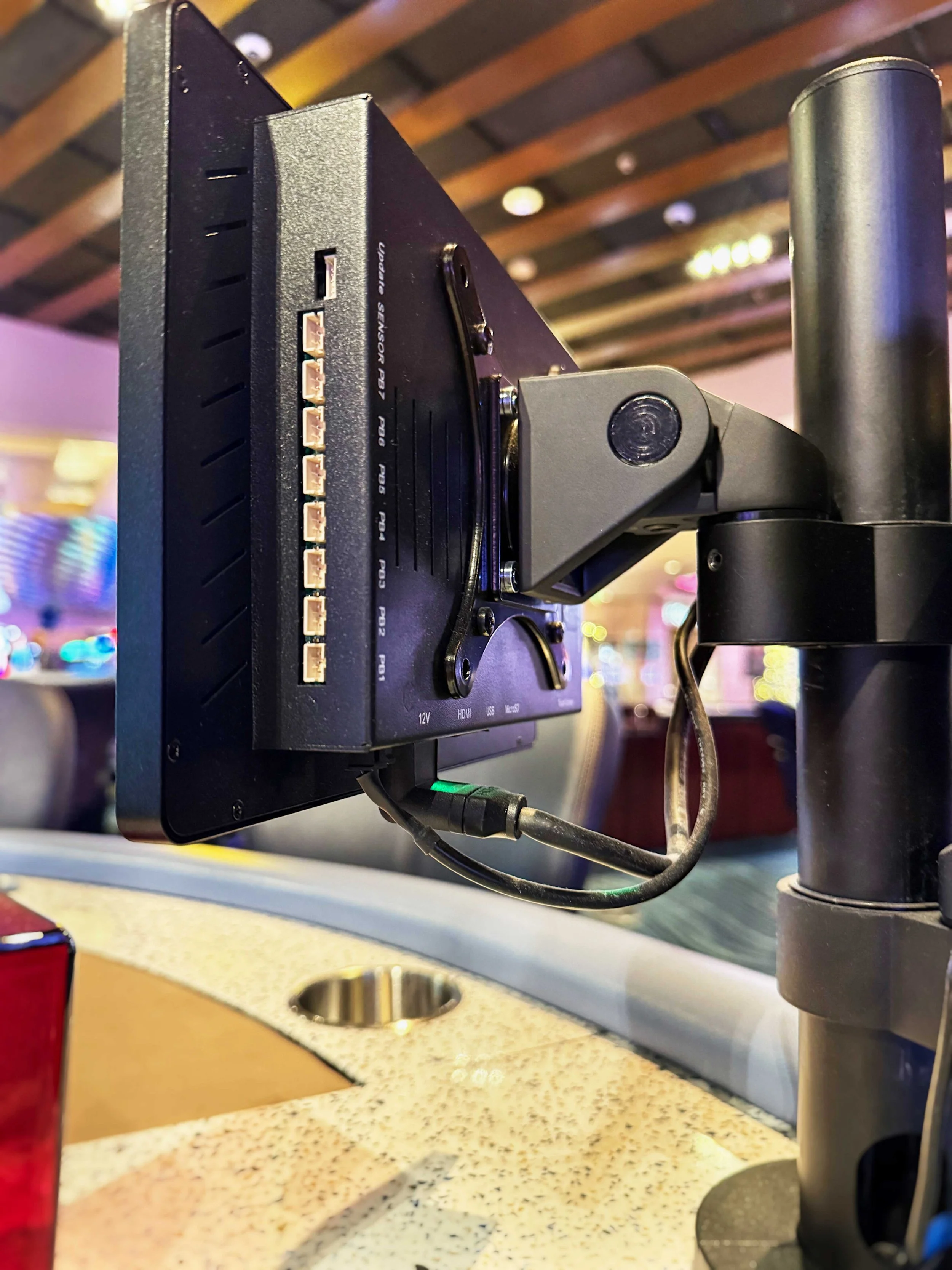 Durable metal housing of a Bluefin digital signage screen mounted cleanly on a casino table games fixture