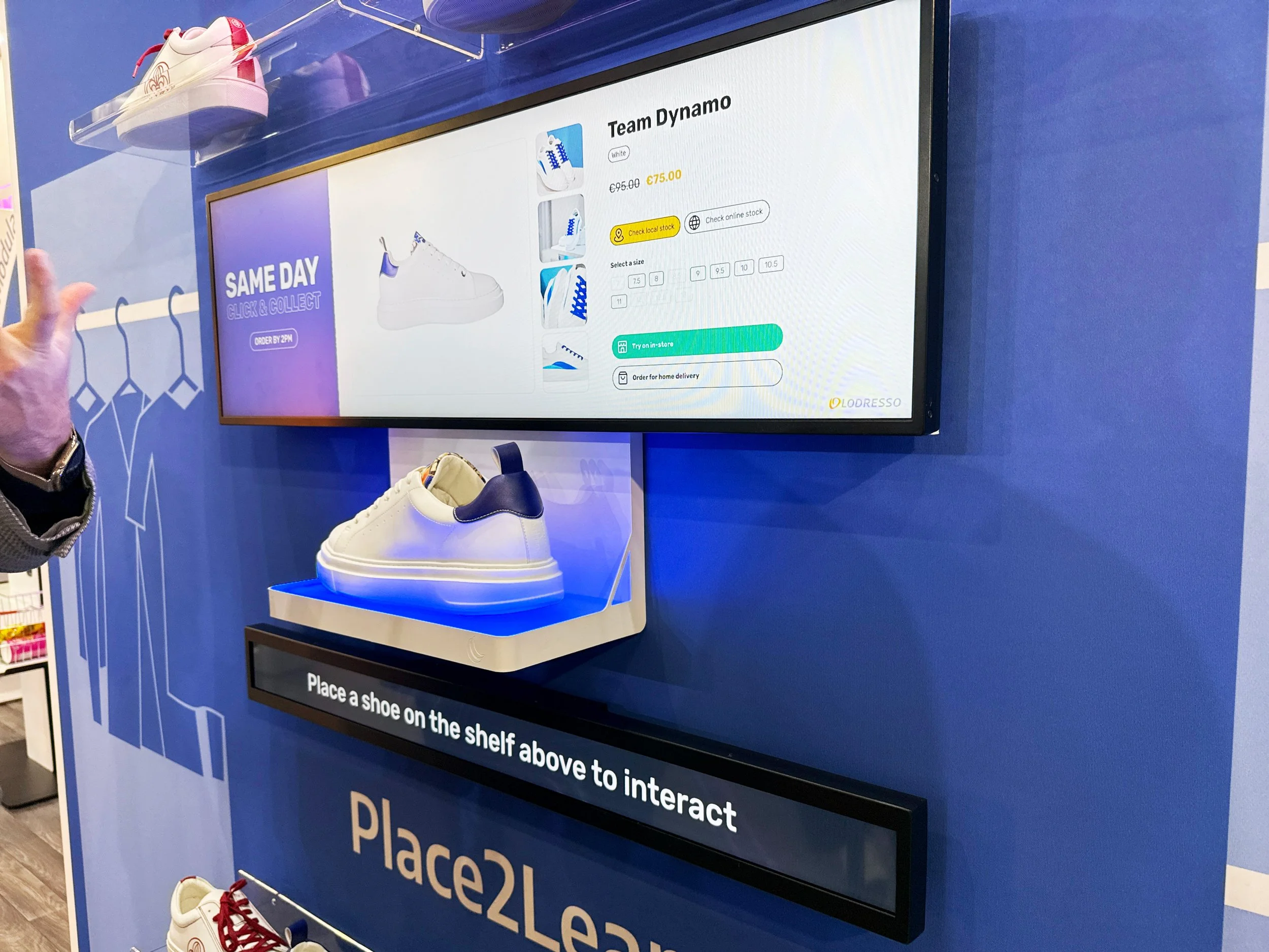 Interactive lift-and-learn retail display featuring a Bluefin stretched LCD strip