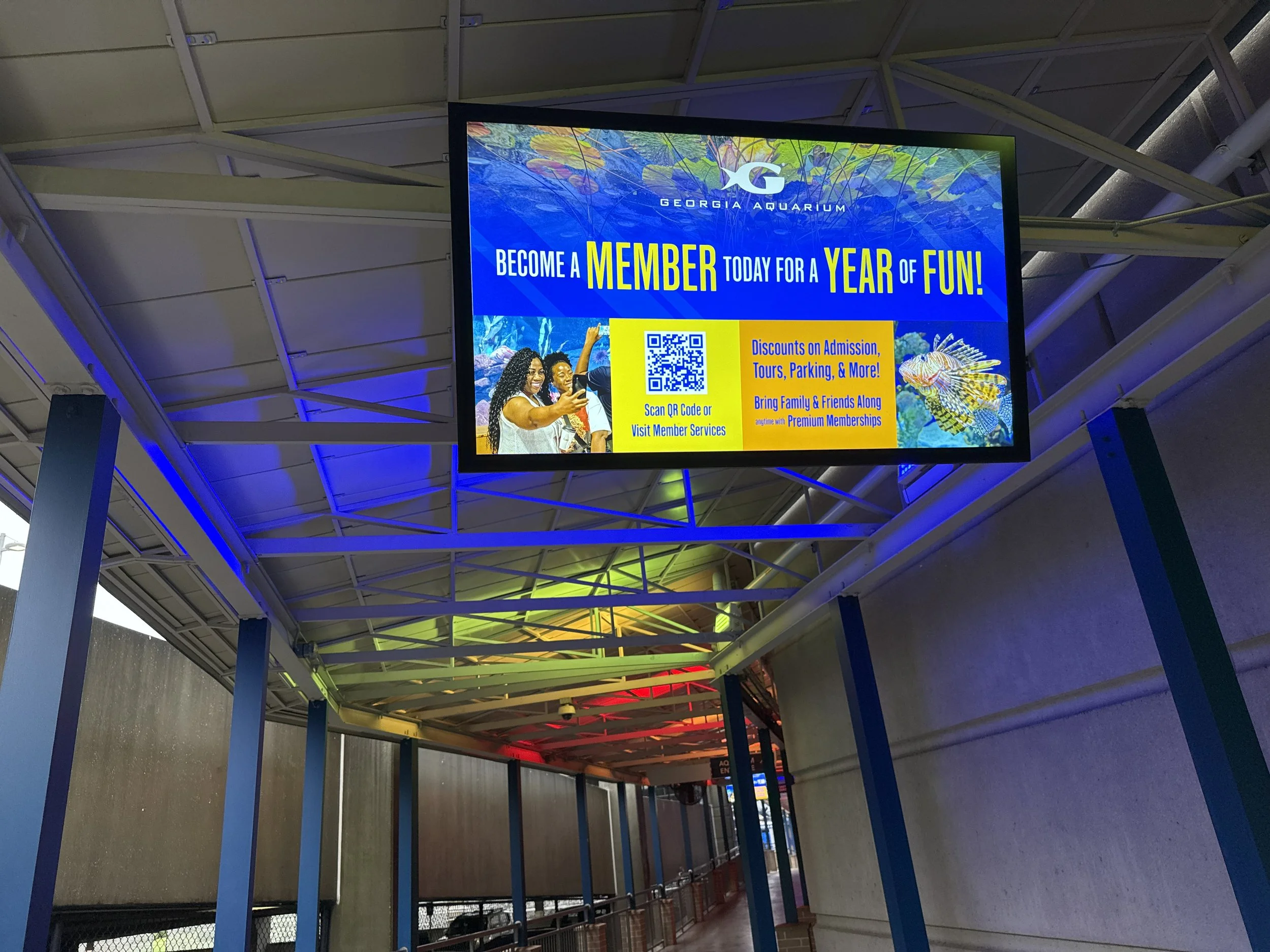 Large format digital display in a museum showcasing upcoming events and exhibitions.