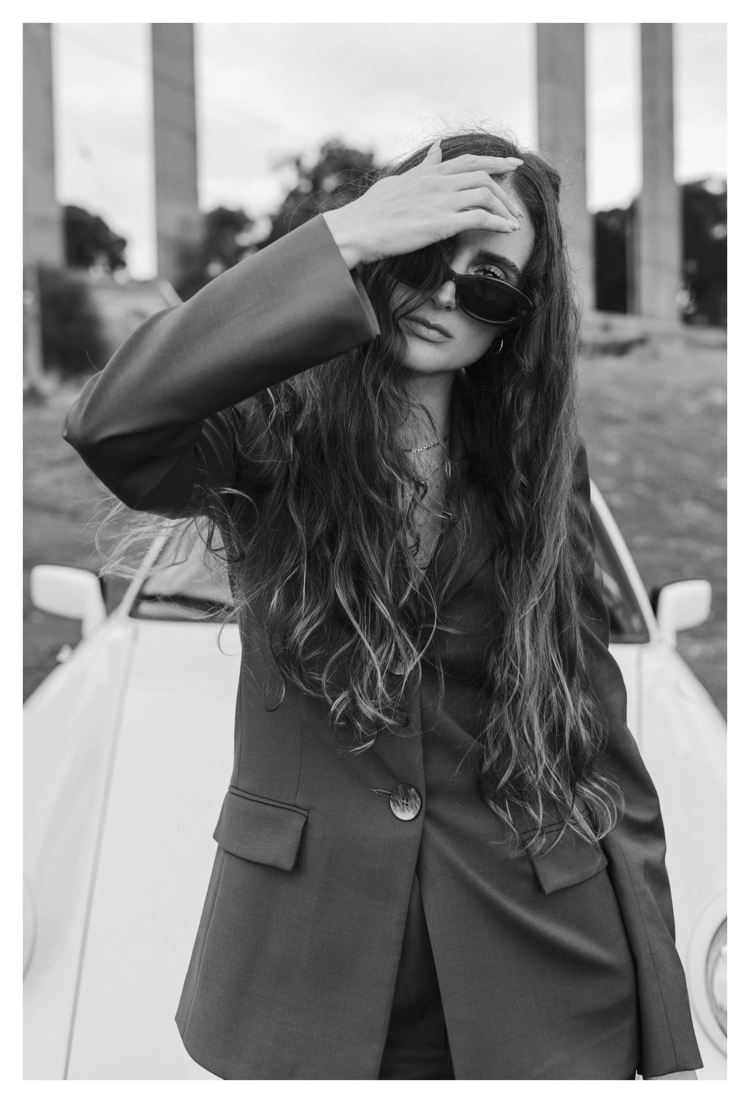 Model poses in front of car.